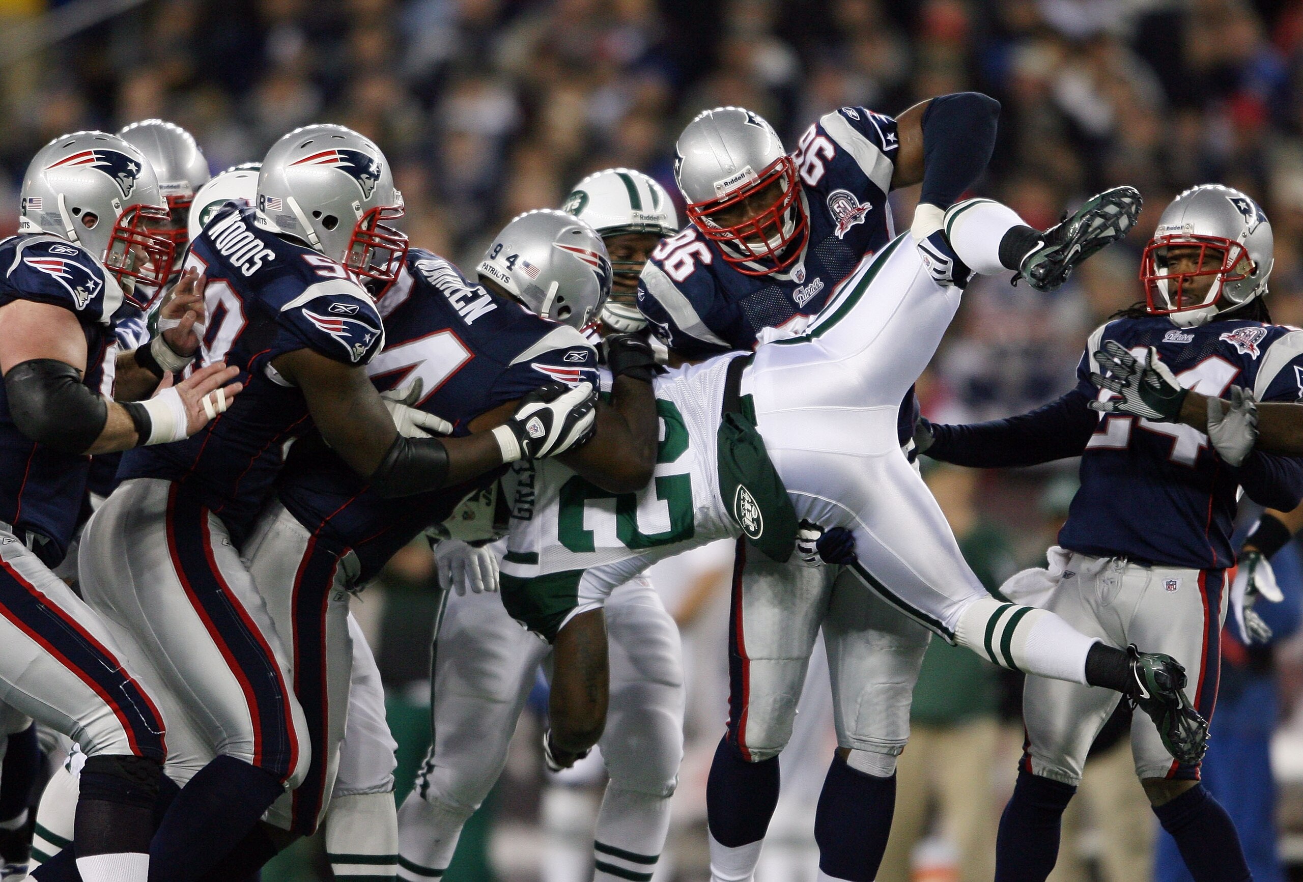 FOXBORO, MA - NOVEMBER 22:  Shonn Greene #23 of the New York Jets is taken down by Adalius Thomas #96, Ty Warren #94 and Pierre Woods #58  of the New England Patriots on November 22, 2009 at Gillette Stadium in Foxboro, Massachusetts.  (Photo by Elsa/Gett