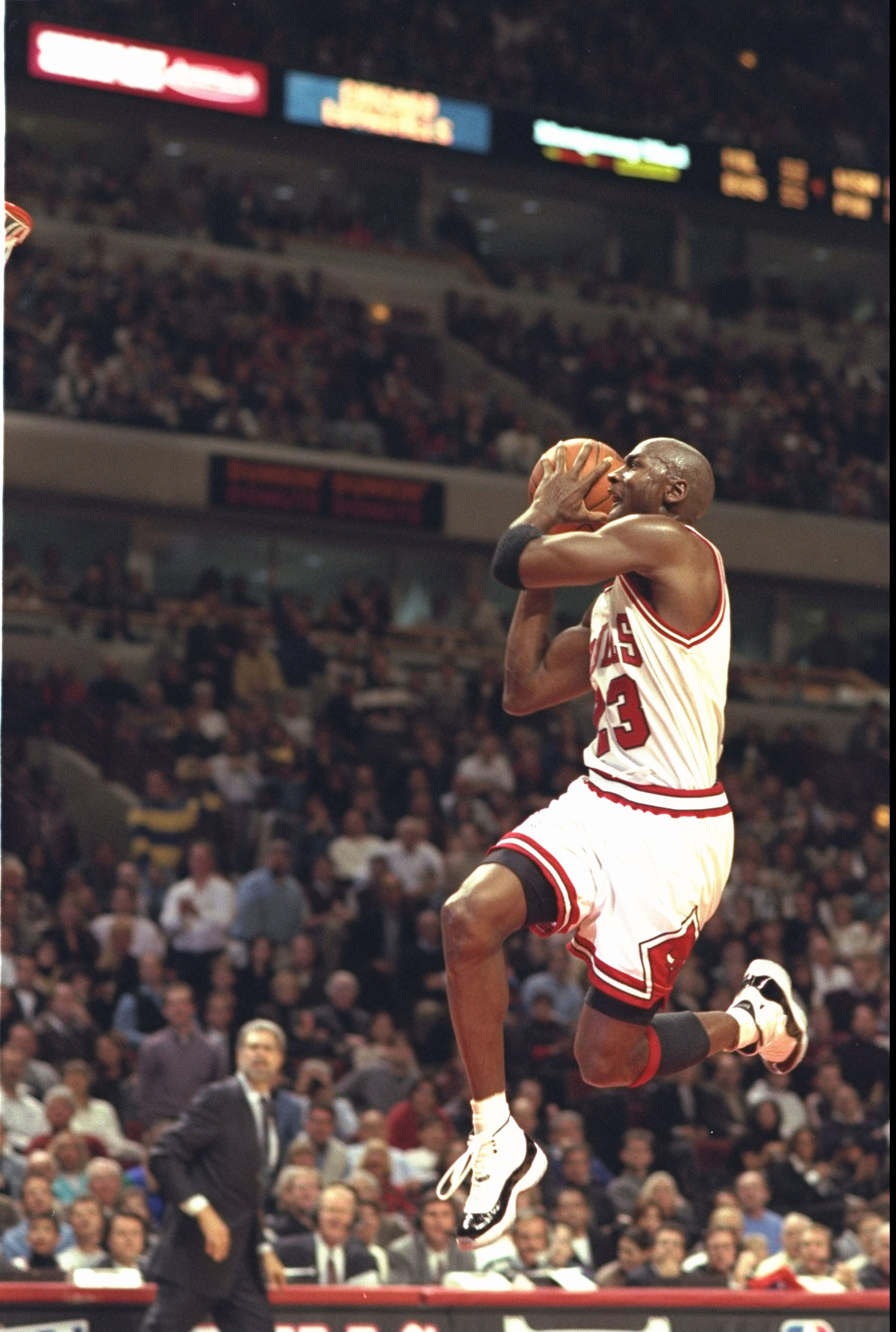 3 Nov 1995:  Guard Michael Jordan #23 of the Chicago Bulls takes to the air in his famous moves to slam dunk against the Charlotte Hornets at the United Center in Chicago, Illinois. The Bulls defeated the Hornets 105-91.  Mandatory Credit:  Jonathan Danie