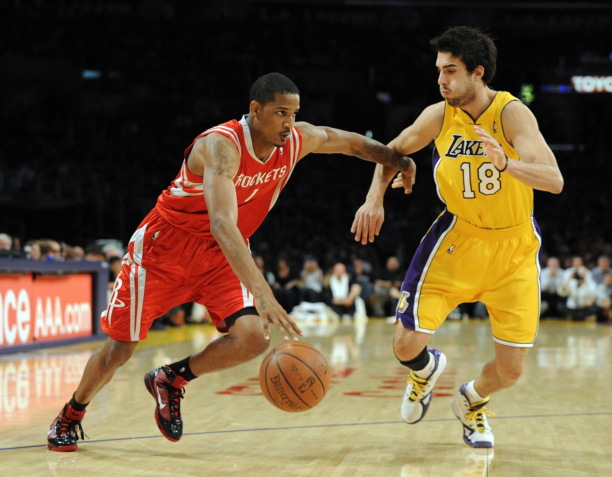 LOS ANGELES, CA - JANUARY 05:  Trevor Ariza #1 of the Houston Rockets dribbles around Sasha Vujacic #18 of the Los Angeles Lakers during the game at Staples Center on January 5, 2010 in Los Angeles, California.  NOTE TO USER: User expressly acknowledges a