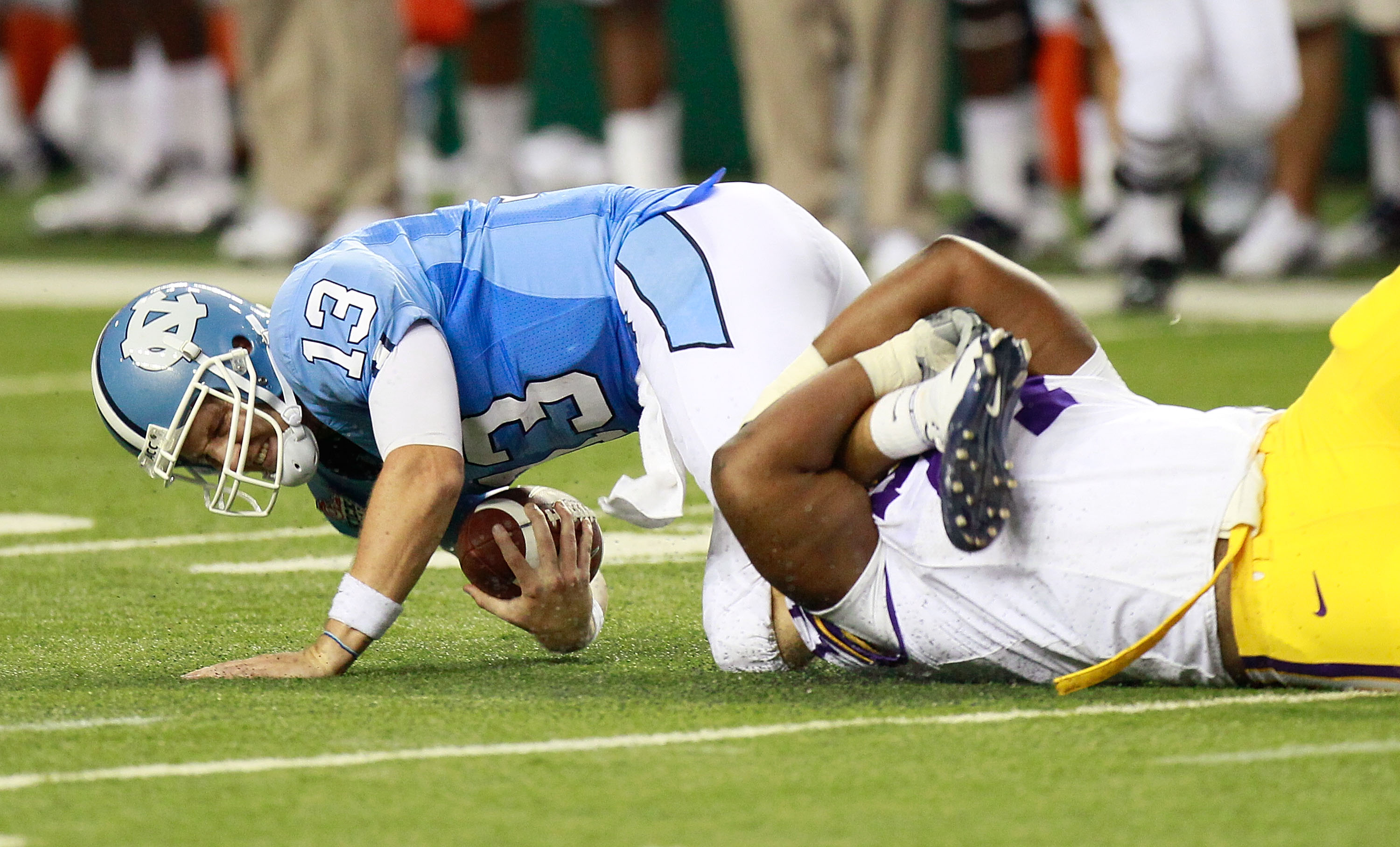 ATLANTA - SEPTEMBER 04:  Josh Downs #77 of the LSU Tigers sacks quarterback T.J. Yates #13 of the North Carolina Tar Heels during the Chick-fil-A Kickoff Game at Georgia Dome on September 4, 2010 in Atlanta, Georgia.  (Photo by Kevin C. Cox/Getty Images)