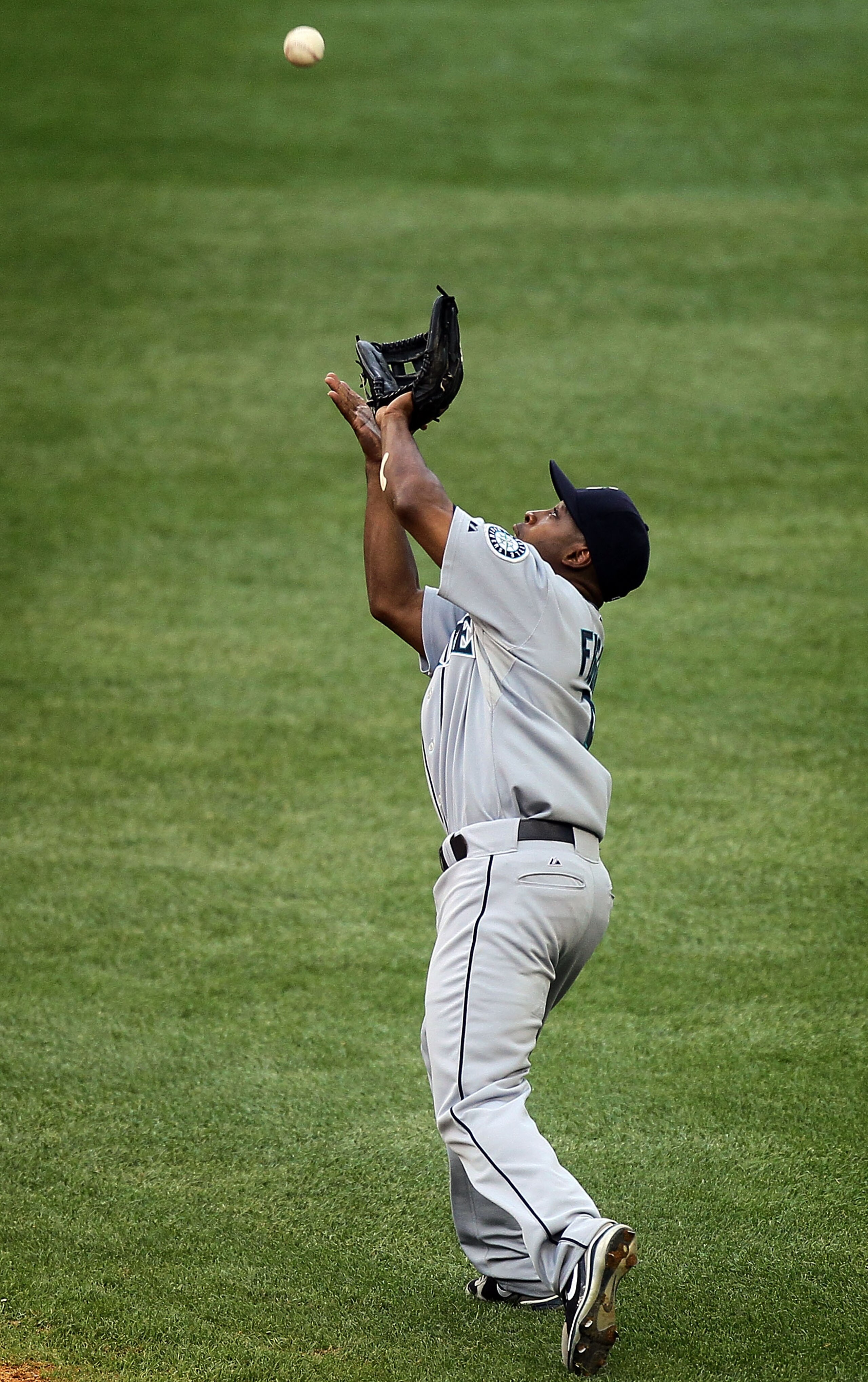NEW YORK - AUGUST 22:  Chone Figgins #9 of the Seattle Mariners makes a catch against the New York Yankees on August 22, 2010 at Yankee Stadium in the Bronx borough of New York City.The Yankees defeated the Mariners 10-0.  (Photo by Jim McIsaac/Getty Imag