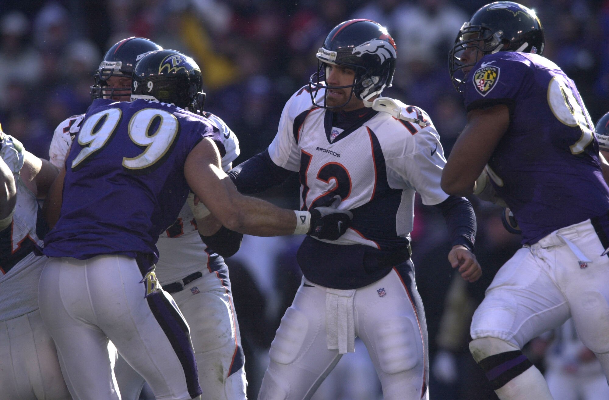 31 Dec 2000:  Gus Ferotte #12 of the Denver Broncos is roughed up by Kevin McCrary #99 and the Baltimore Ravens defense as the Ravens defeated the Broncos 21-3 in their AFC Wildcard playoff game at PSINet Stadium in Baltimore, Maryland. DIGITAL IMAGE Mand