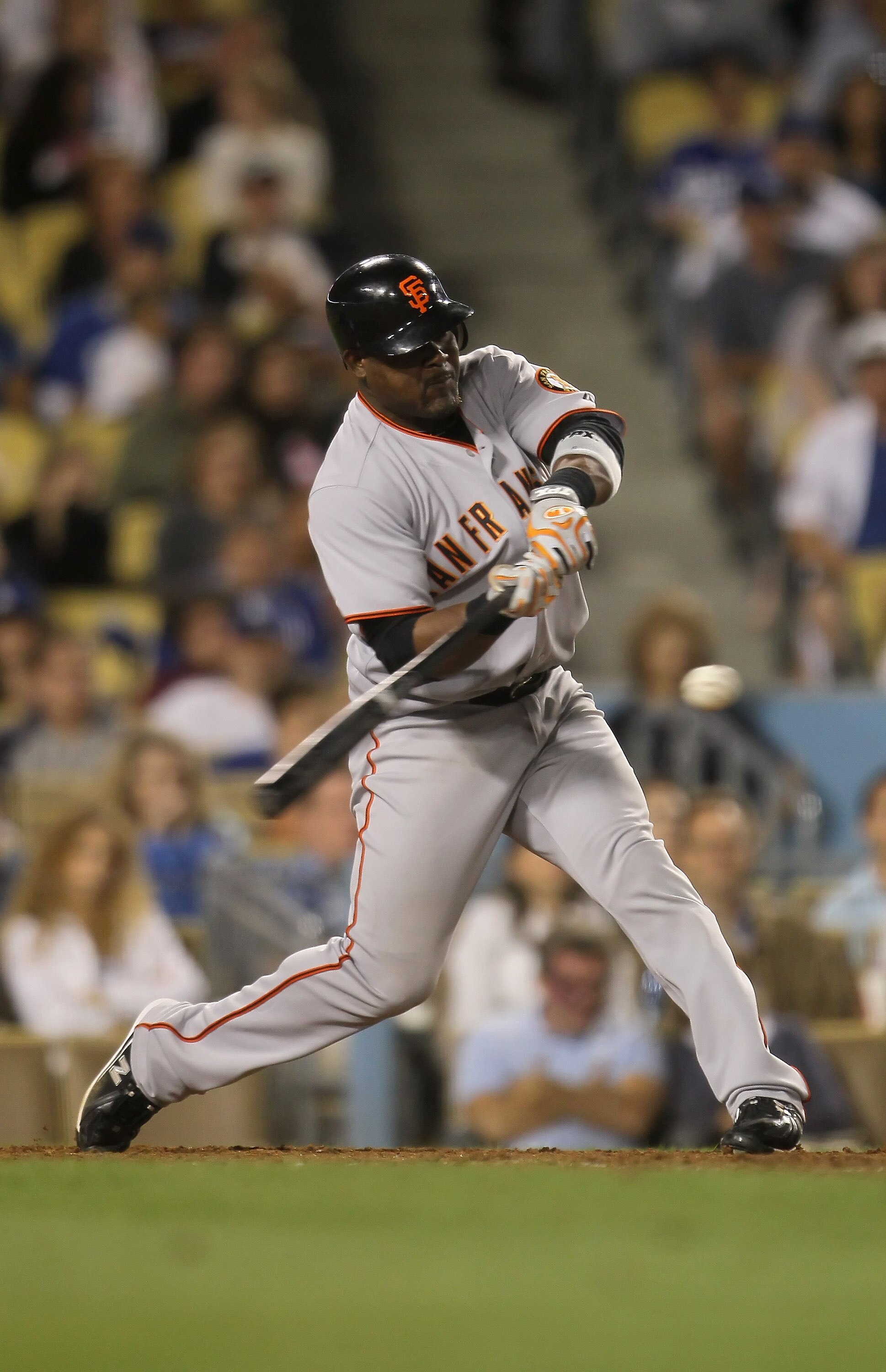 LOS ANGELES, CA - SEPTEMBER 04:  Juan Uribe #5 of the San Francisco Giants hits a two-run home run against the Los Angeles Dodgers in the ninth inning at Dodger Stadium on September 4, 2010 in Los Angeles, California. The Giants defeated the Dodgers 5-4.