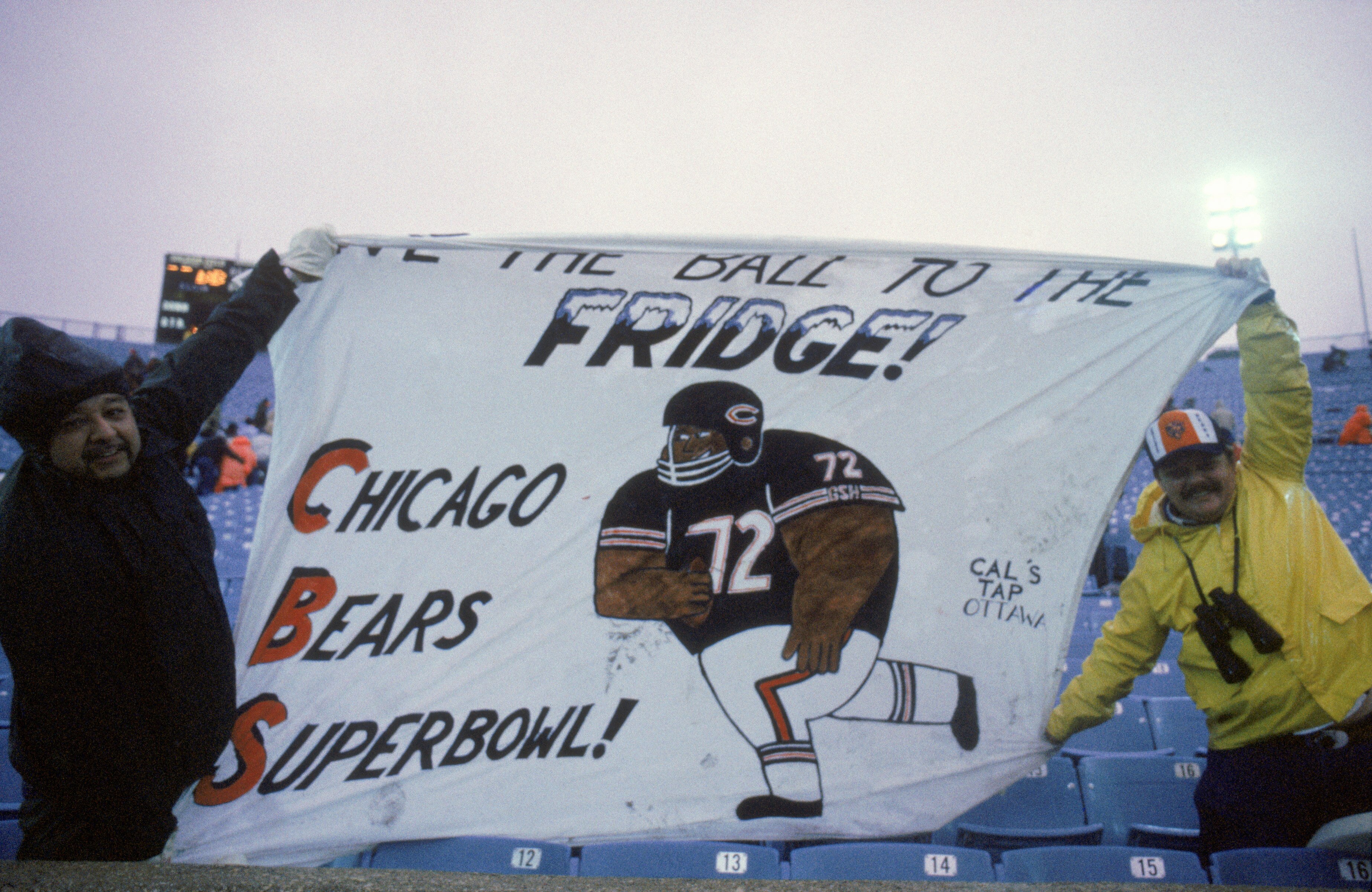 CHICAGO - 1985:  Fans of defensive lineman William Perry #72 of the Chicago Bears display a banner which reads 'Give the Ball to the Fridge' during a game between the Bears and the Detroit Lions in 1985 at Soldier Field in Chicago, Illinois.  The Bears wo