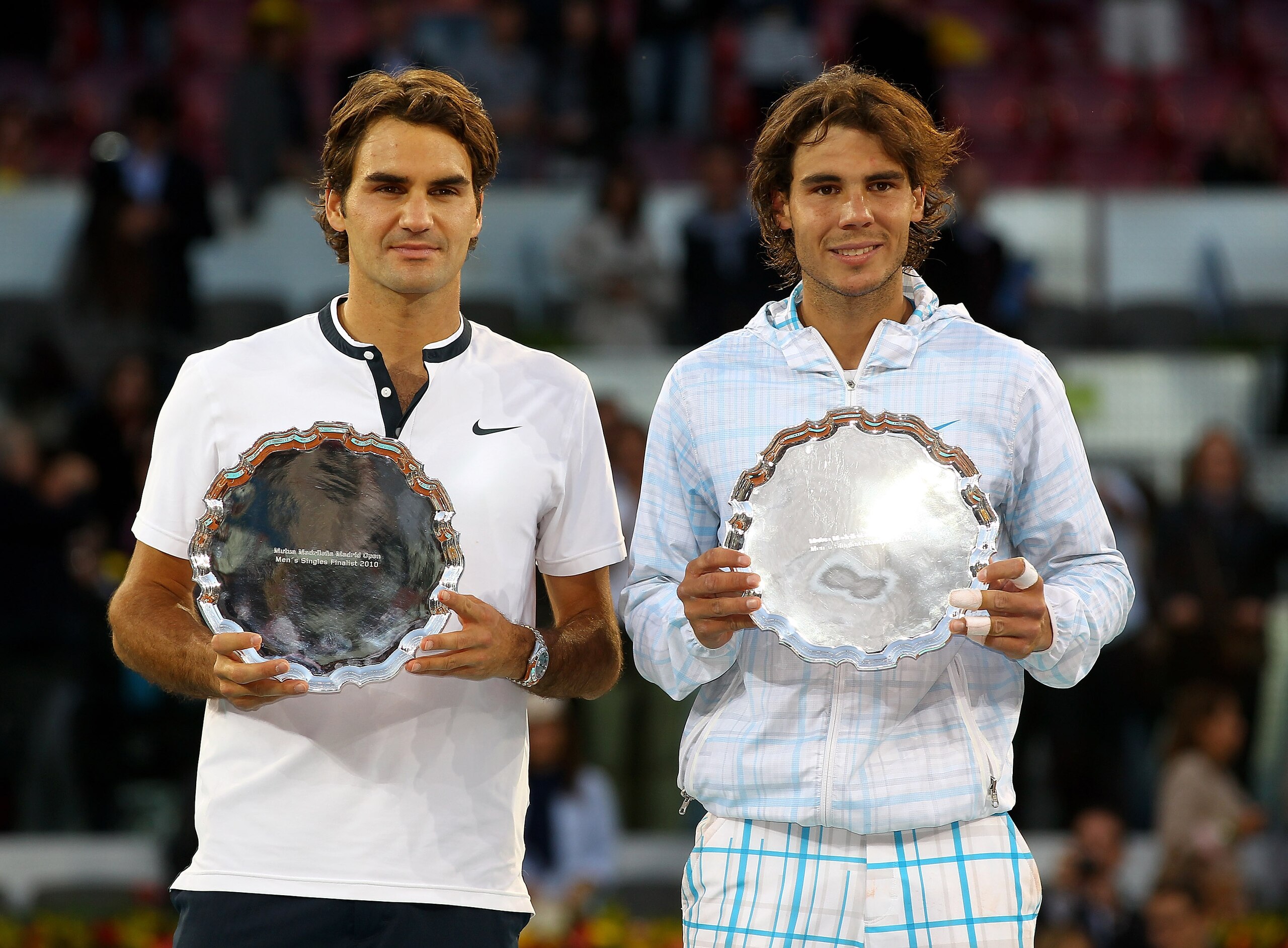 MADRID, SPAIN - MAY 16: Mens finalist Rafael Nadal and Roger Federer of Switzerland hold aloft their trophies after the mens final match during the Mutua Madrilena Madrid Open tennis tournament at the Caja Magica on May 16, 2010 in Madrid, Spain. (Phot MADRID, SPAIN - MAY 16: Mens finalist Rafael Nadal and Roger Federer of Switzerland hold aloft their trophies after the mens final match during the Mutua Madrilena Madrid Open tennis tournament at the Caja Magica on May 16, 2010 in Madrid, Spain. (Phot