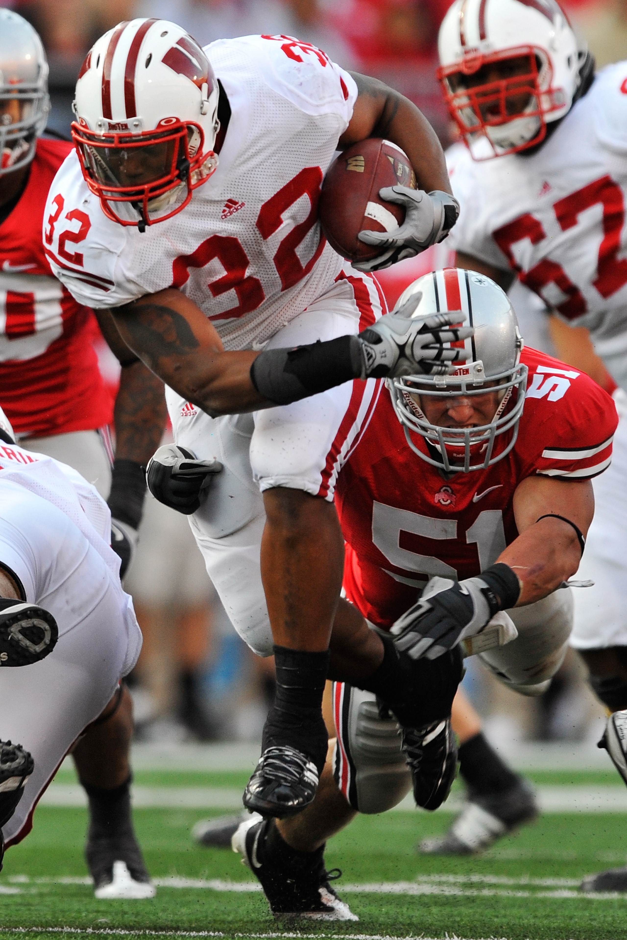 COLUMBUS, OH - OCTOBER 10:  Running back John Clay #32 of the Wisconsin Badgers hops away from the grasp of Ross Homan #51 of the Ohio State Buckeyes at Ohio Stadium on October 10, 2009 in Columbus, Ohio.  (Photo by Jamie Sabau/Getty Images)