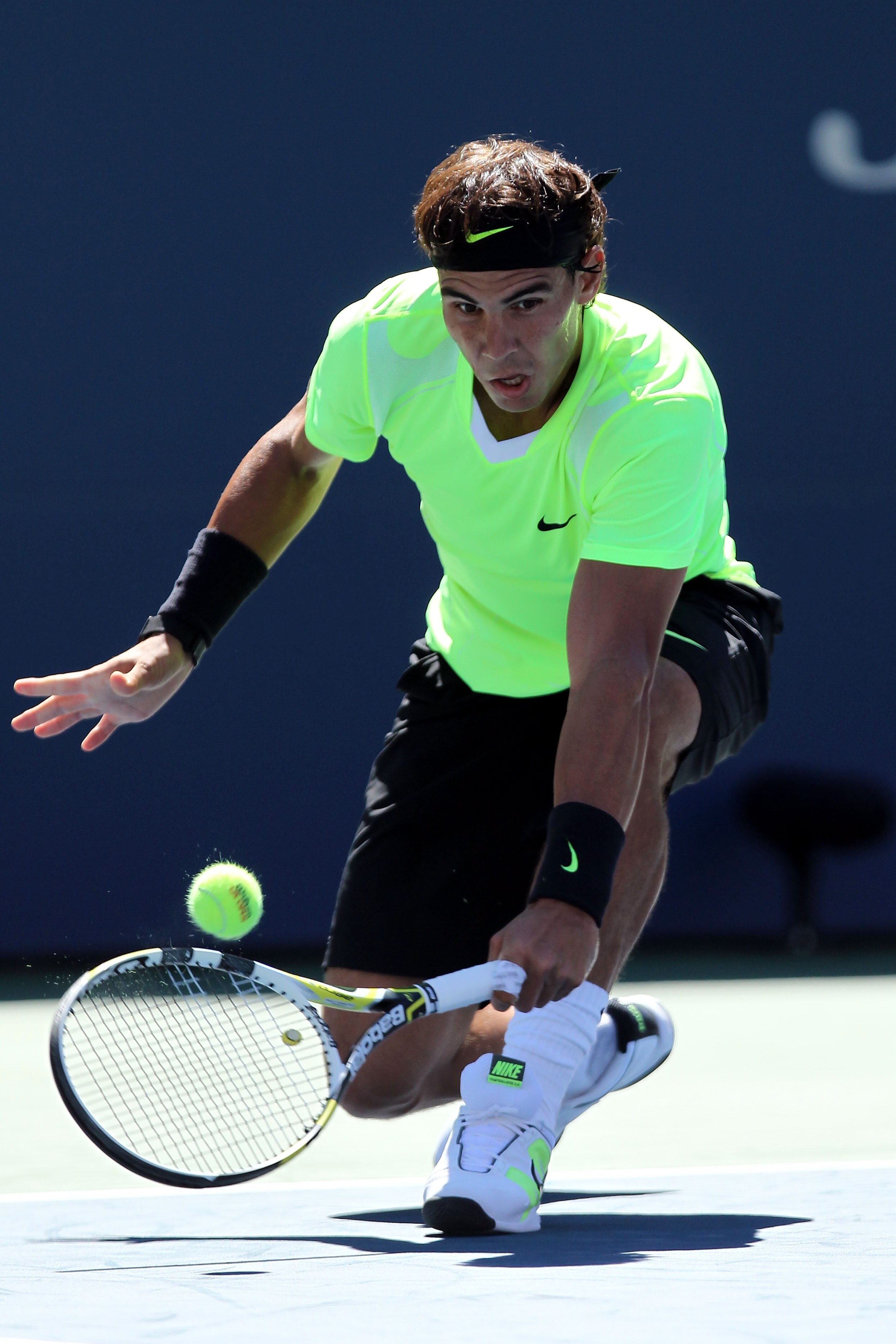 NEW YORK - SEPTEMBER 11:  Rafael Nadal of Spain returns a shot while playing against Mikhail Youzhny of Russia during his men's singles semifinal match on day thirteen of the 2010 U.S. Open at the USTA Billie Jean King National Tennis Center on September