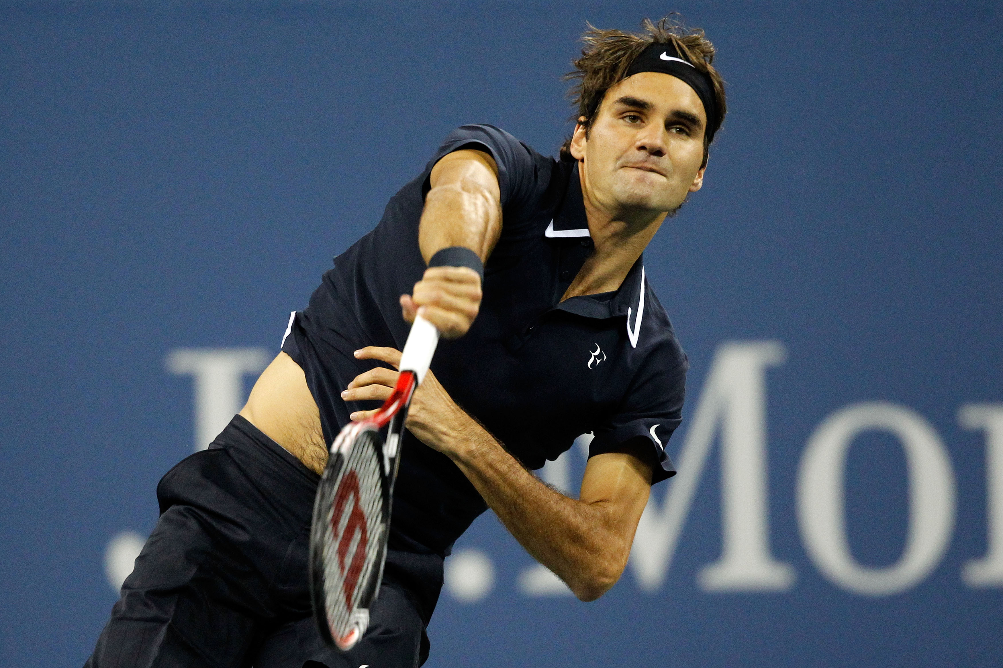 NEW YORK - SEPTEMBER 08:  Roger Federer of Switzerland serves against Robin Soderling of Sweden during his men's singles quarterfinal match on day ten of the 2010 U.S. Open at the USTA Billie Jean King National Tennis Center on September 8, 2010 in the Fl