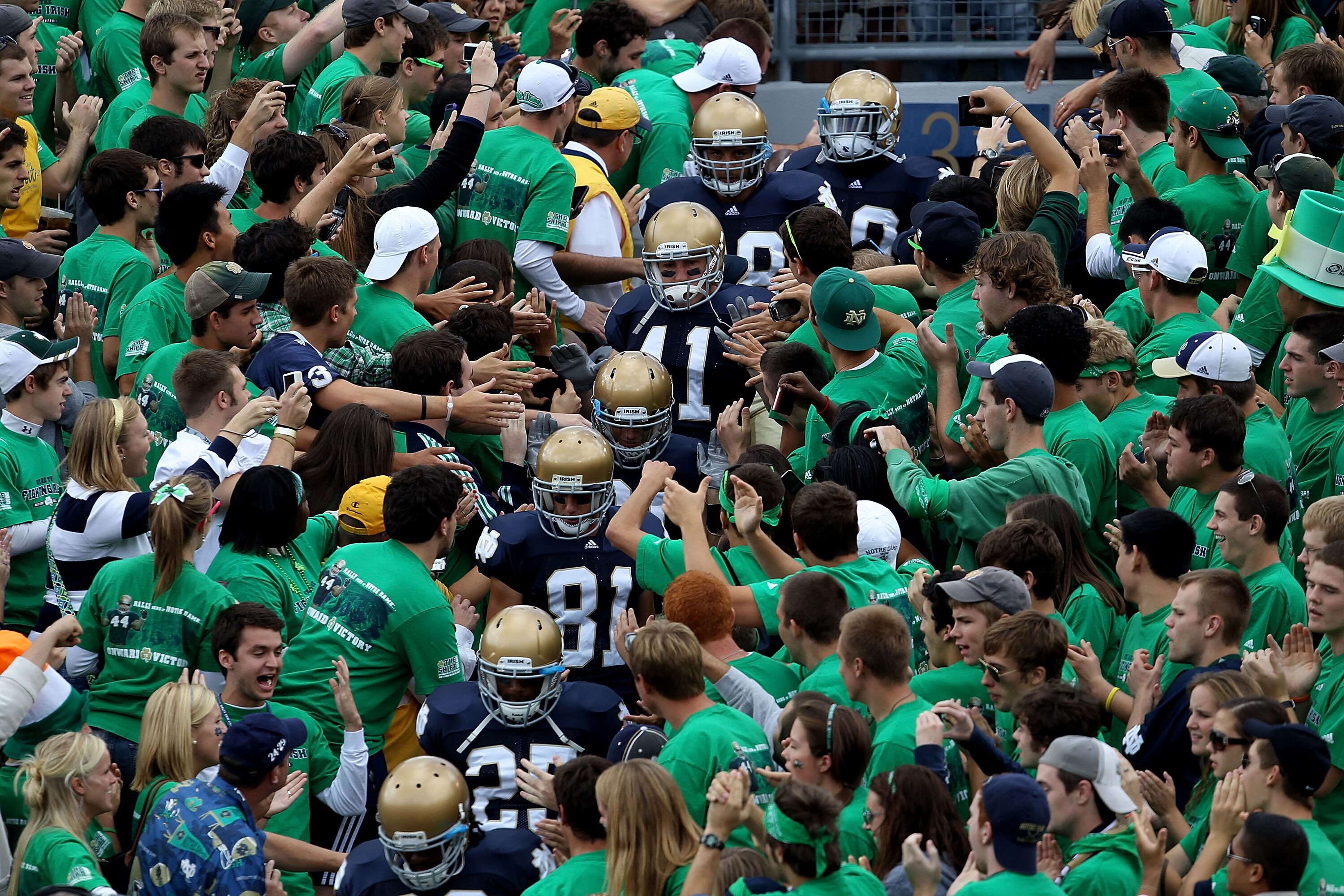 SOUTH BEND, IN - SEPTEMBER 04: Players from the Notre Dame Fighting Irish walk to the field through the student section for warm-ups before a game against the Purdue Boilermakers at Notre Dame Stadium on September 4, 2010 in South Bend, Indiana. Notre Dam