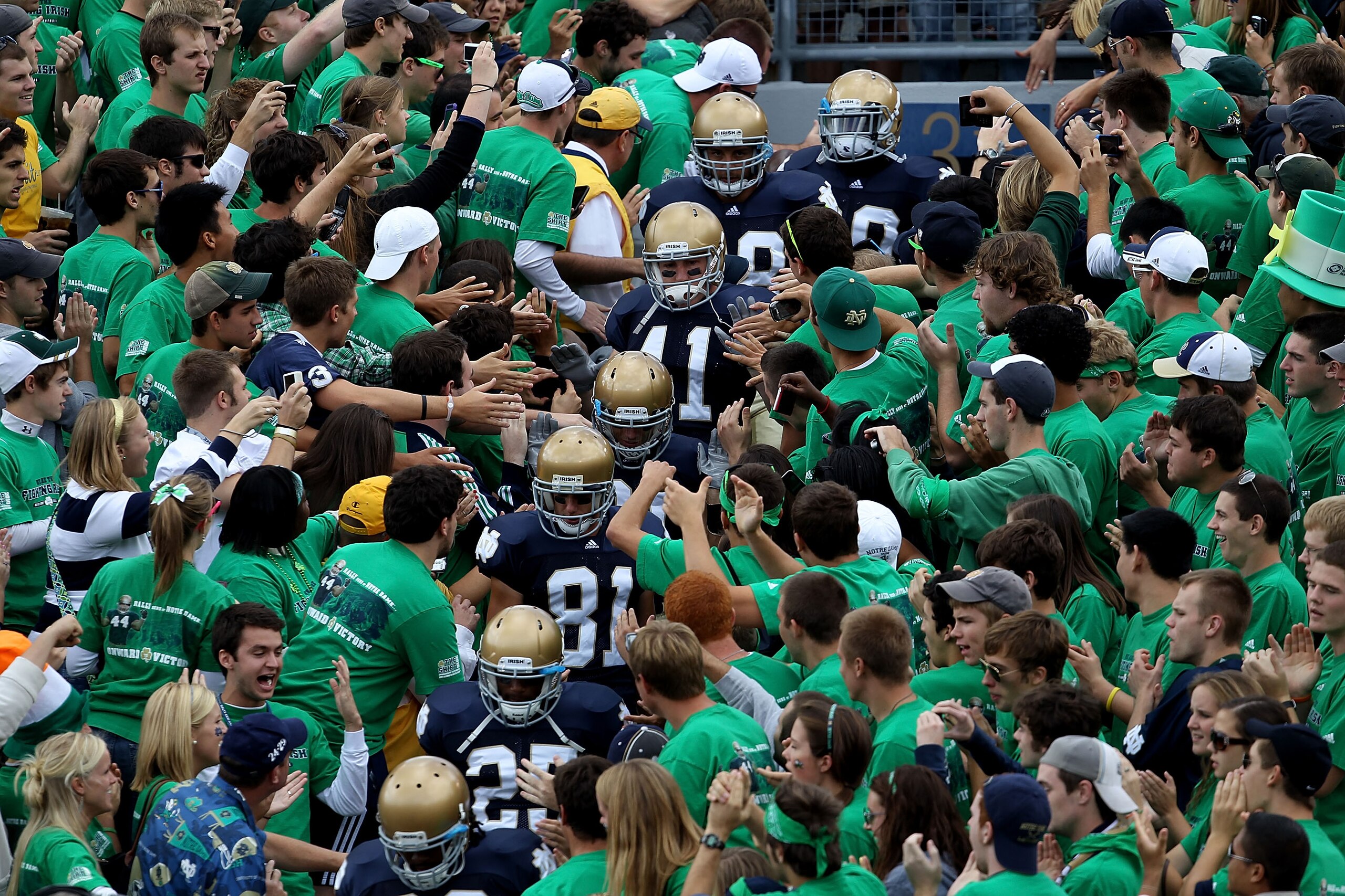 SOUTH BEND, IN - SEPTEMBER 04: Players from the Notre Dame Fighting Irish walk to the field through the student section for warm-ups before a game against the Purdue Boilermakers at Notre Dame Stadium on September 4, 2010 in South Bend, Indiana. Notre Dam