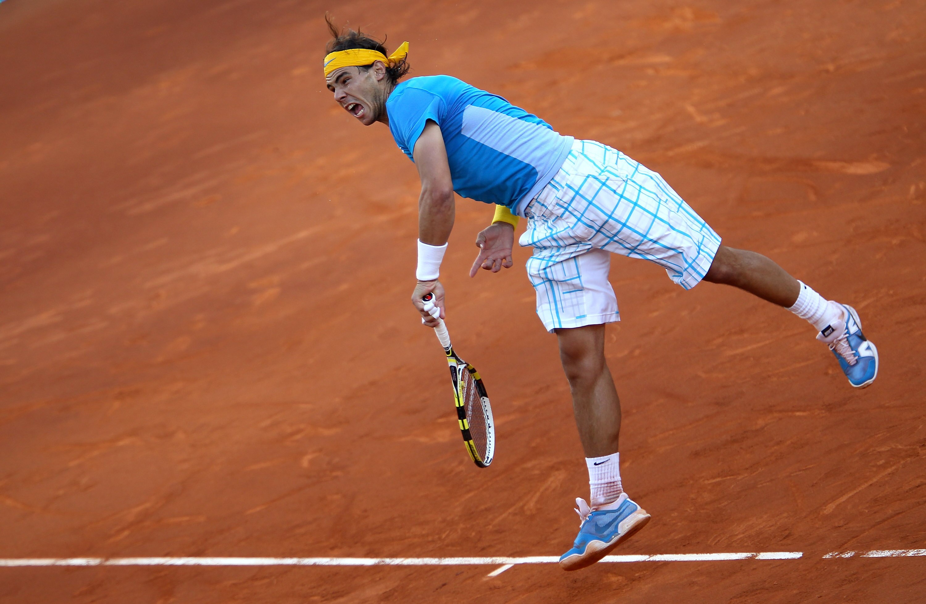 MADRID, SPAIN - MAY 16:  Rafael Nadal of Spain serves against Roger Federer of Switzerland in the mens final match during the Mutua Madrilena Madrid Open tennis tournament at the Caja Magica on May 16, 2010 in Madrid, Spain.  (Photo by Clive Brunskill/Get