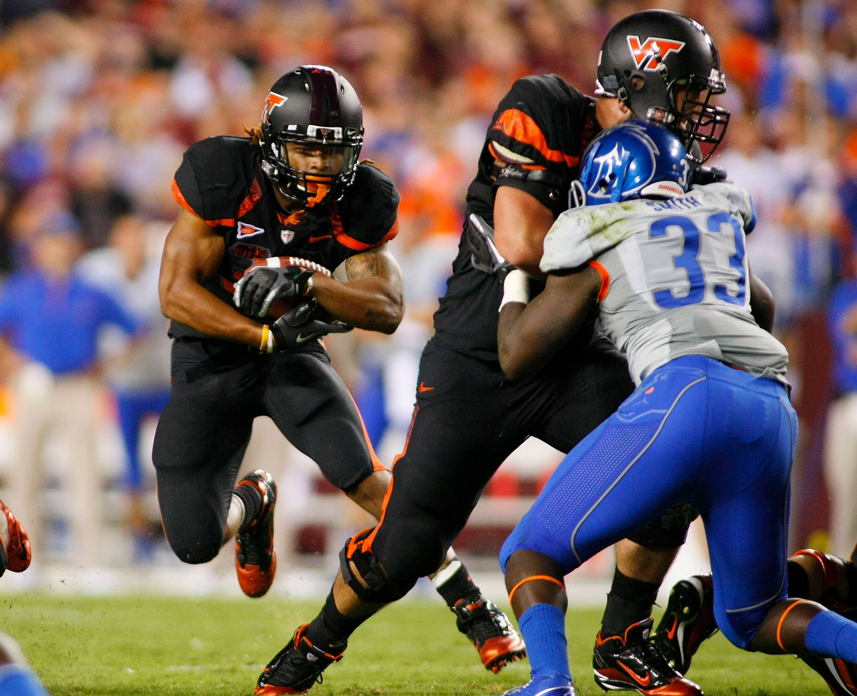 LANDOVER, MD - SEPTEMBER 06:  Running back Darren Evans #32 of the Virginia Tech Hokies runs past linebacker Tommy Smith #33 of the Boise State Broncos at FedExField on September 6, 2010 in Landover, Maryland.  (Photo by Geoff Burke/Getty Images)