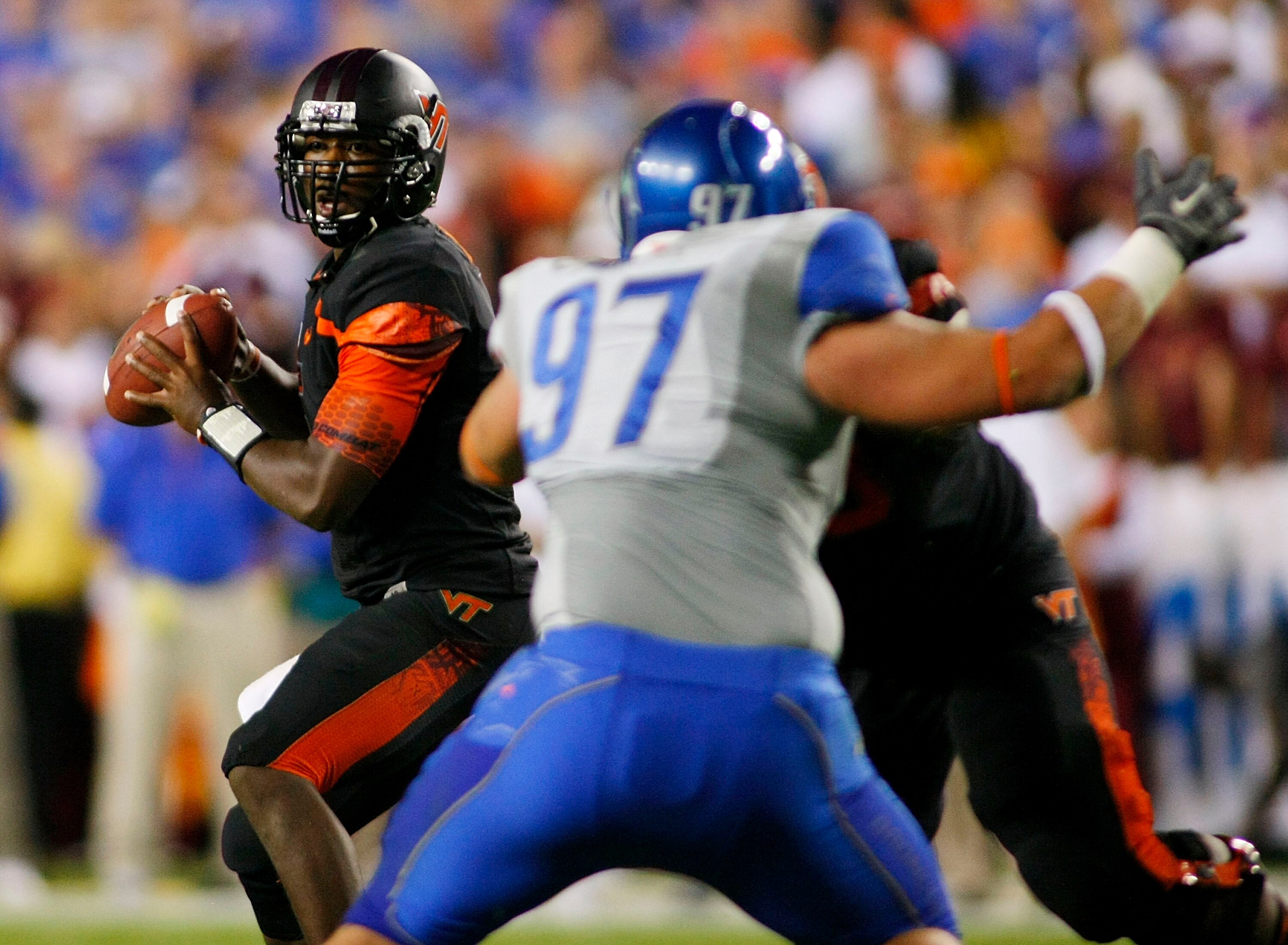 LANDOVER, MD - SEPTEMBER 06:  Quarterback Tyrod Taylor #7 of the Virginia Tech Hokies looks to pass as Chase Baker #97 of the Boise State Broncos defends at FedExField on September 6, 2010 in Landover, Maryland.  (Photo by Geoff Burke/Getty Images)