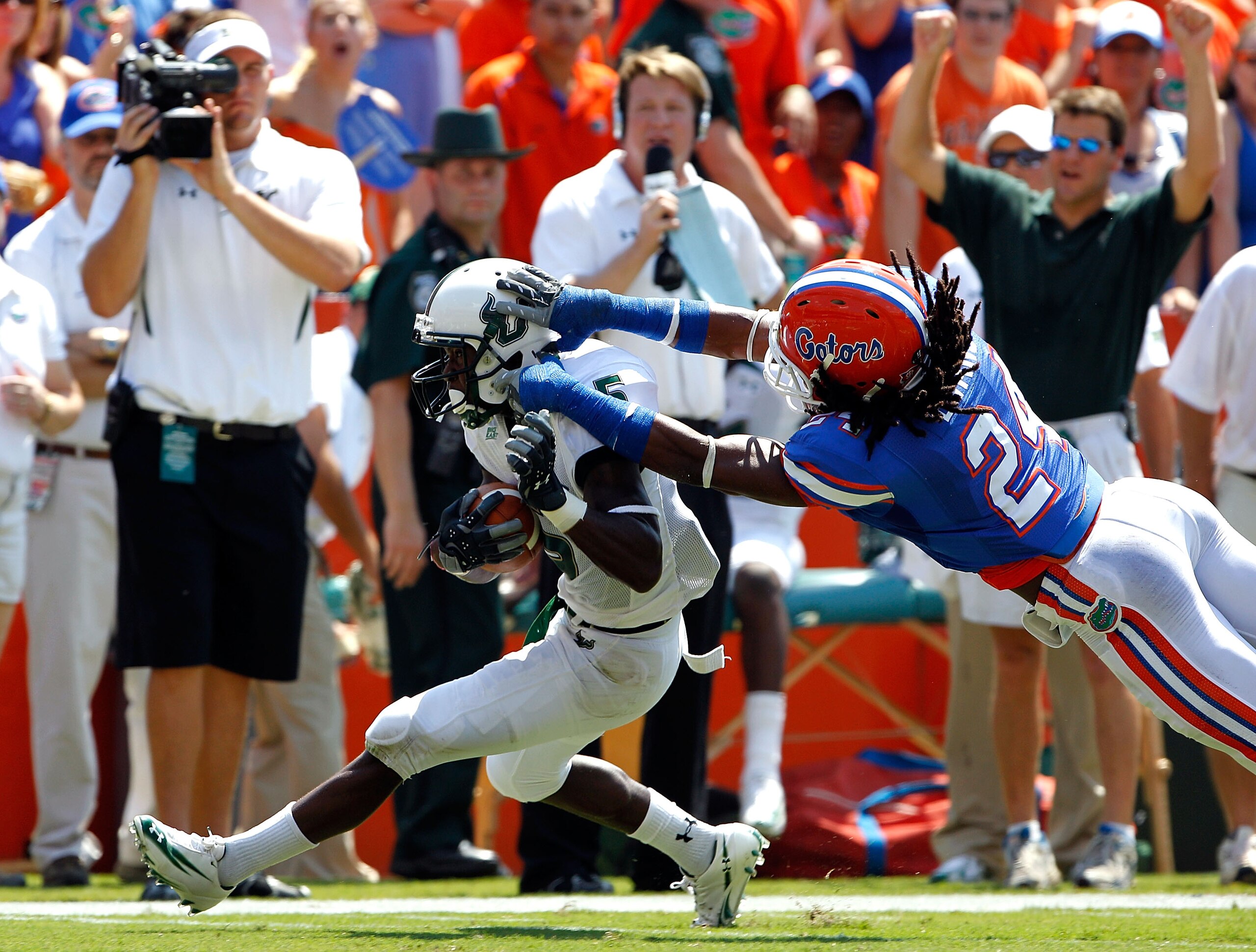 GAINESVILLE, FL - SEPTEMBER 11:   Josh Evans #24 of the Florida Gators attempts to tackle Lindsey Lamar #5 of the South Florida Bulls during a game at Ben Hill Griffin Stadium on September 11, 2010 in Gainesville, Florida.  (Photo by Sam Greenwood/Getty I