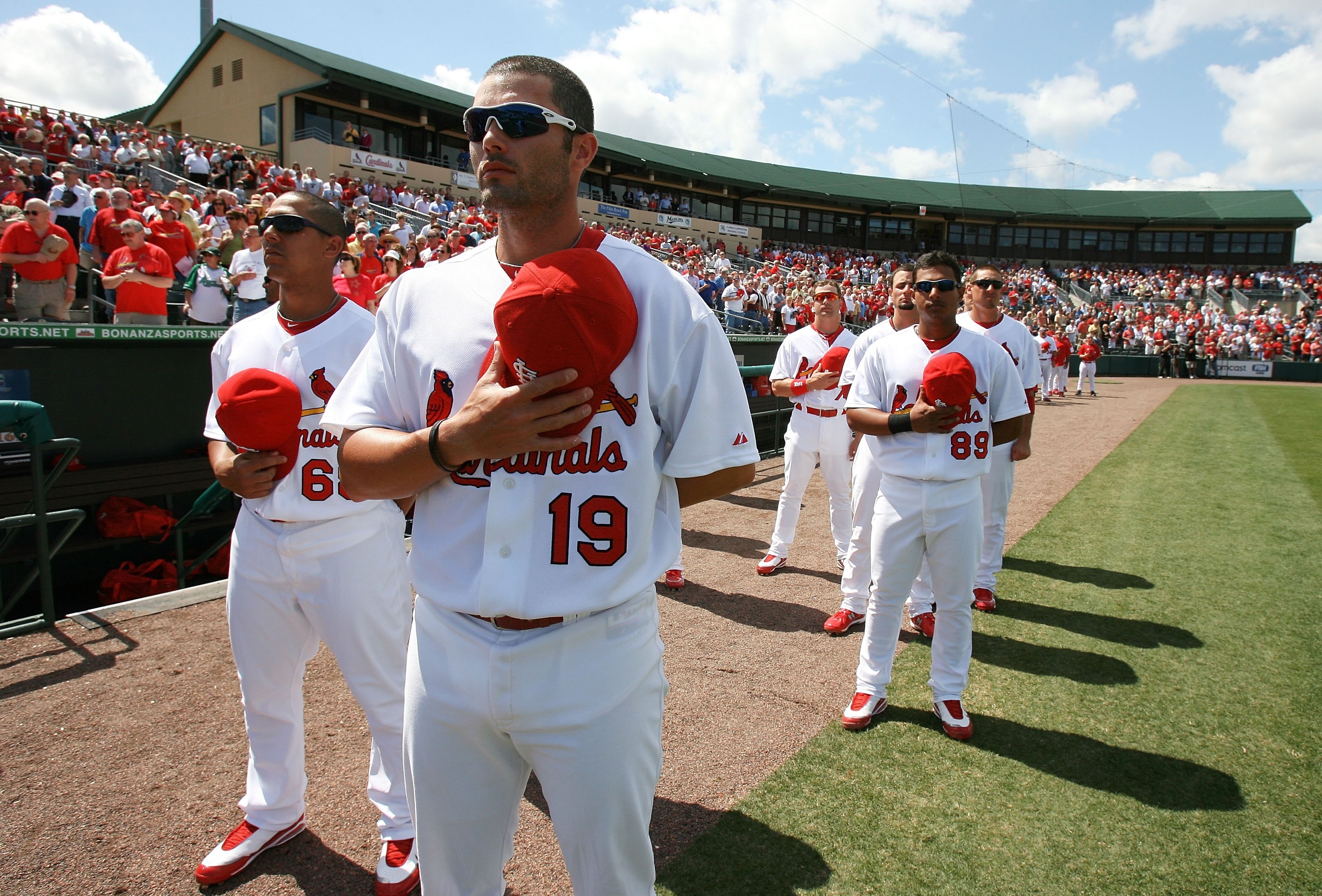 JUPITER, FL - MARCH 10:  Catcher Matt Pagnozzi #19 of the St Louis Cardinals along with other teammates pauses for the National Anthem before taking on the Washington Nationals at Roger Dean Stadium on March 10, 2010 in Jupiter, Florida.  (Photo by Doug B