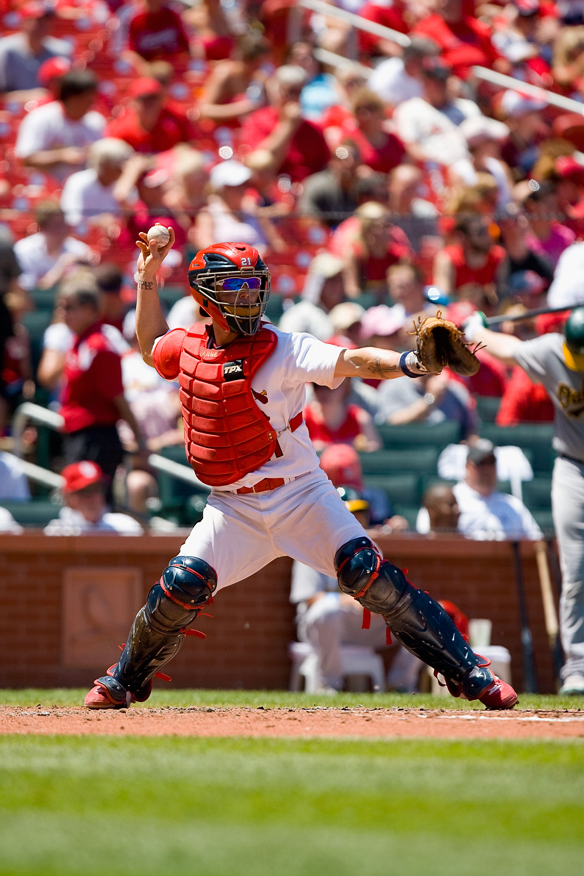 ST. LOUIS - JUNE 20: Jason LaRue #21 of the St. Louis Cardinals throws to first base against the Oakland Athletics at Busch Stadium on June 20, 2010 in St. Louis, Missouri.  (Photo by Dilip Vishwanat/Getty Images)
