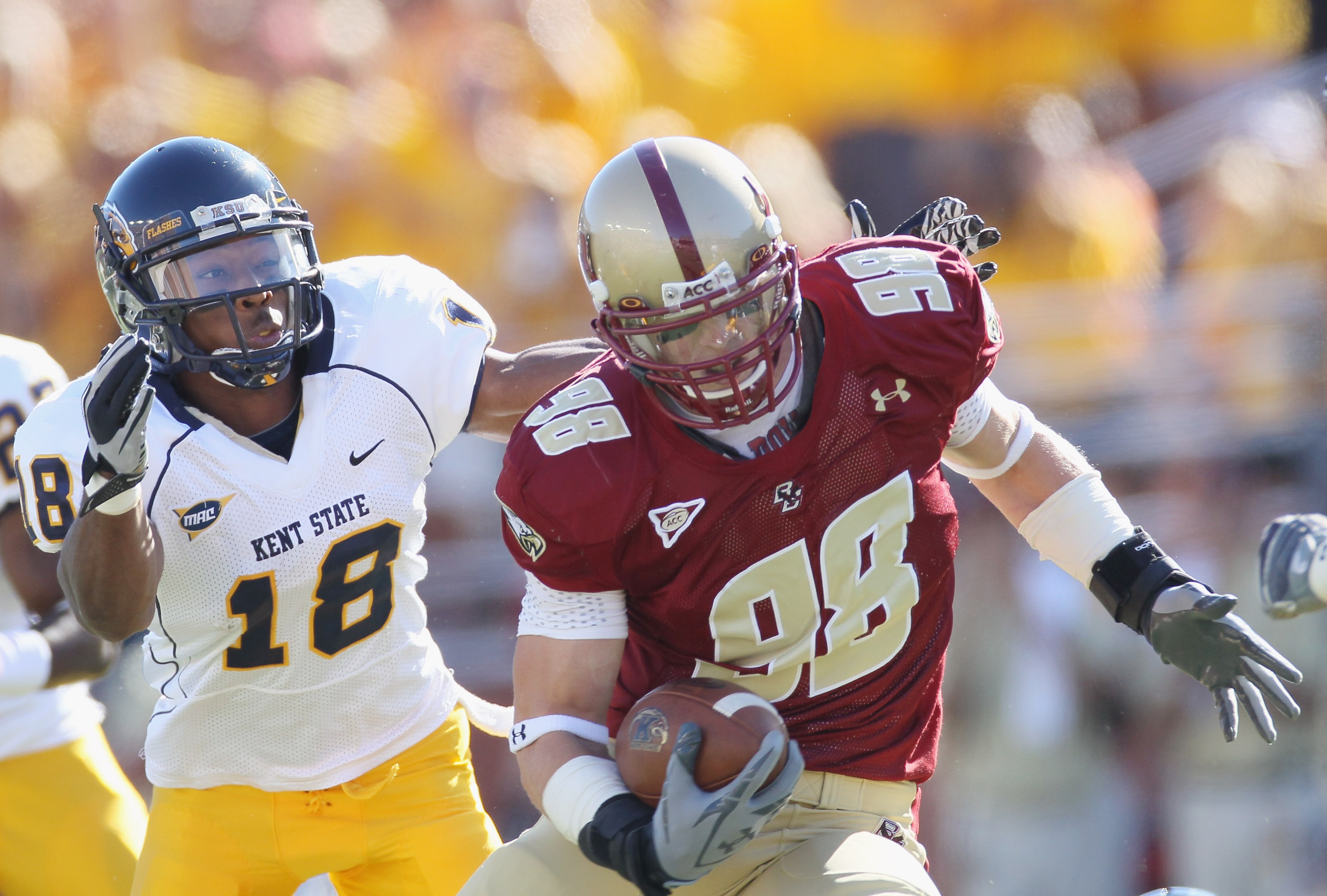 CHESTNUT HILL, MA - SEPTEMBER 11:  Alex Albright #98 of the Boston College Eagles carries the ball after he intercepted a pass as Sam Kirkland #18 of the Kent State Golden Flashes defends on September 11, 2010 at Alumni Stadium in Chestnut Hill, Massachus