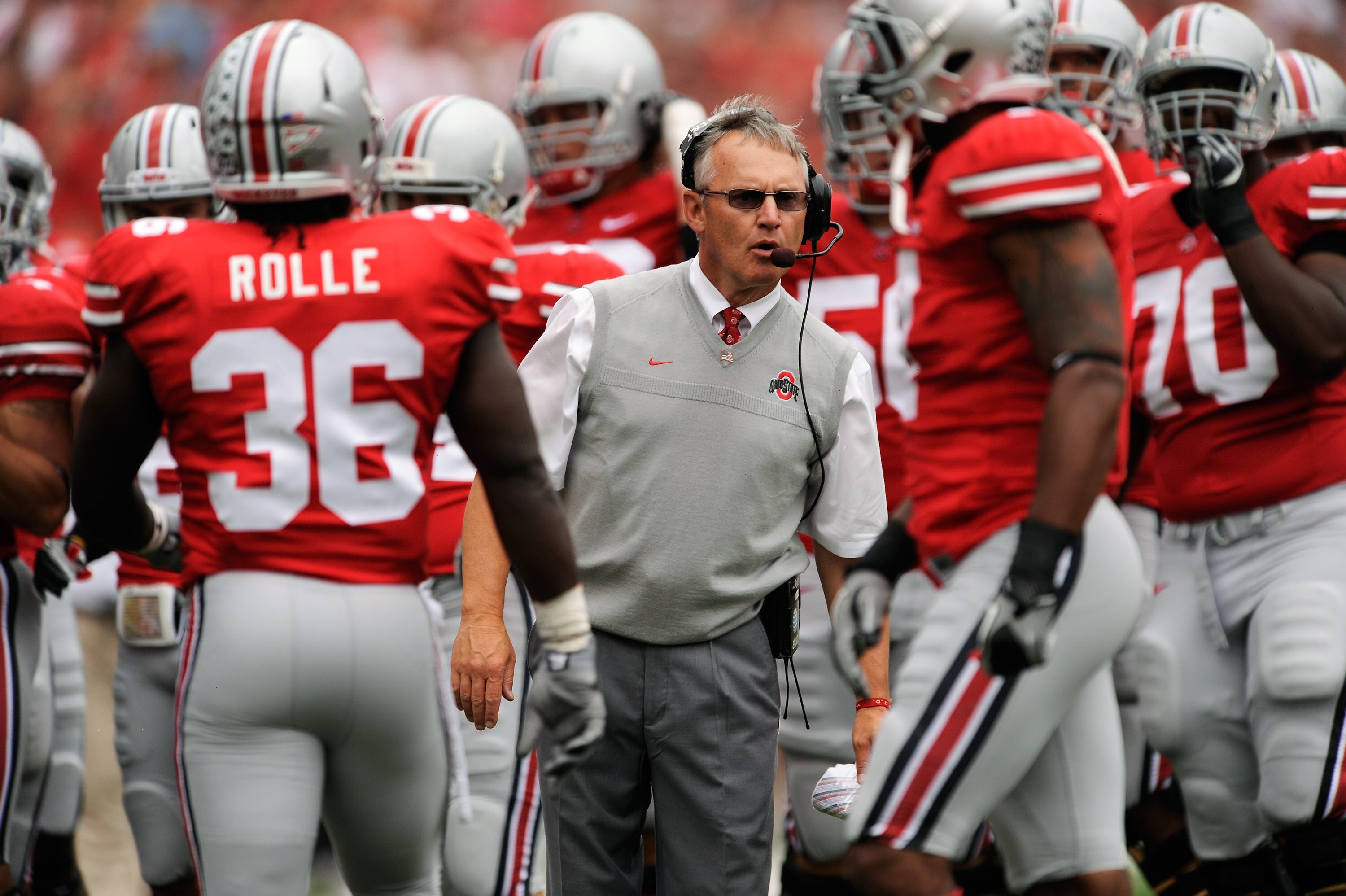 COLUMBUS, OH - SEPTEMBER 11:  Head Coach Jim Tressel (C) of the Ohio State Buckeyes gives instructions to his players as they play the Miami Hurricanes at Ohio Stadium on September 11, 2010 in Columbus, Ohio.  (Photo by Jamie Sabau/Getty Images)