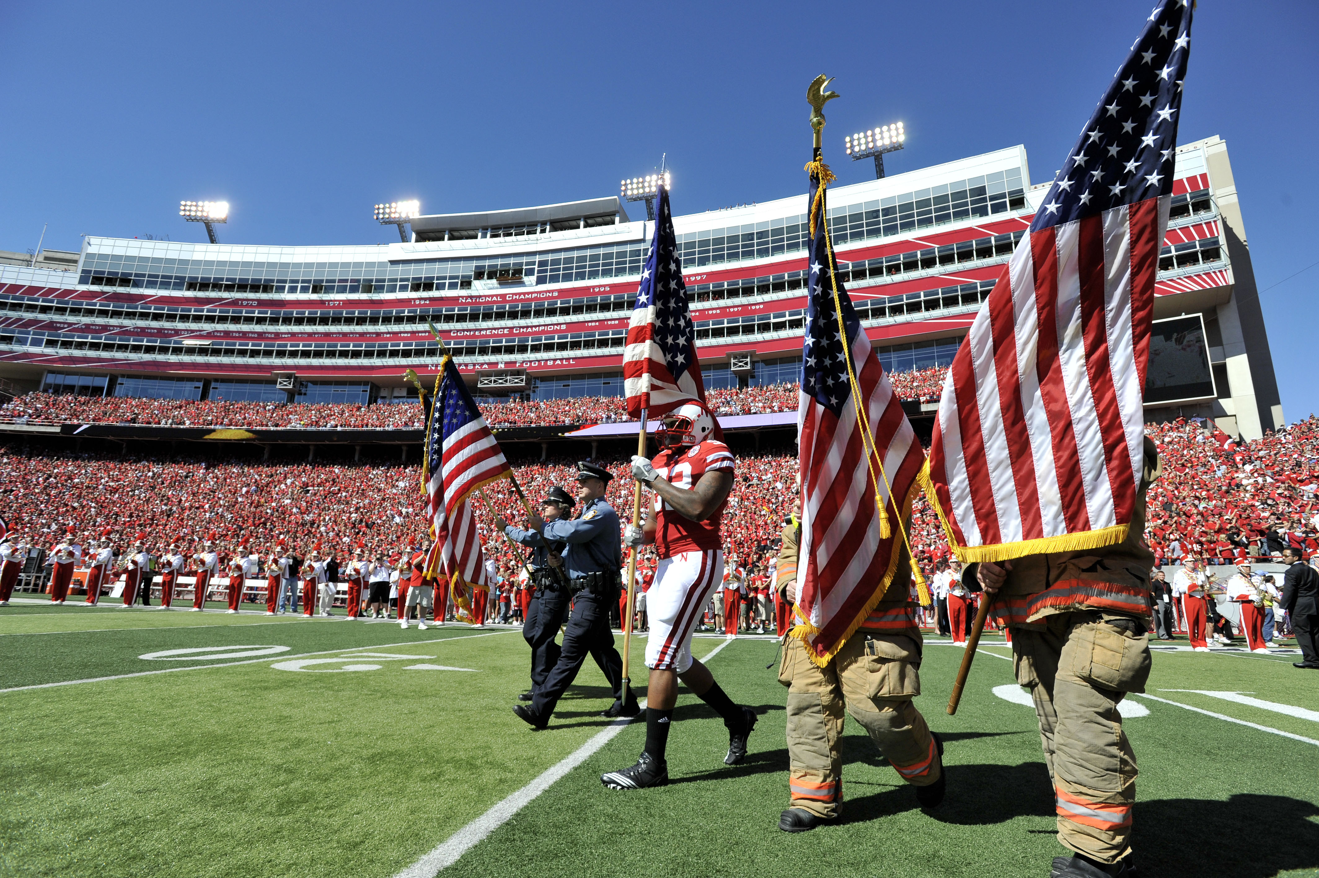 LINCOLN, NE - SEPTEMBER 11: Nebraska Cornhuskers defensive end Tyrone Fahie #92 carries the American Flag onto the field before their game against the Idaho Vandals at Memorial Stadium on September 4, 2010 in Lincoln, Nebraska. Nebraska Defeated Idaho  38