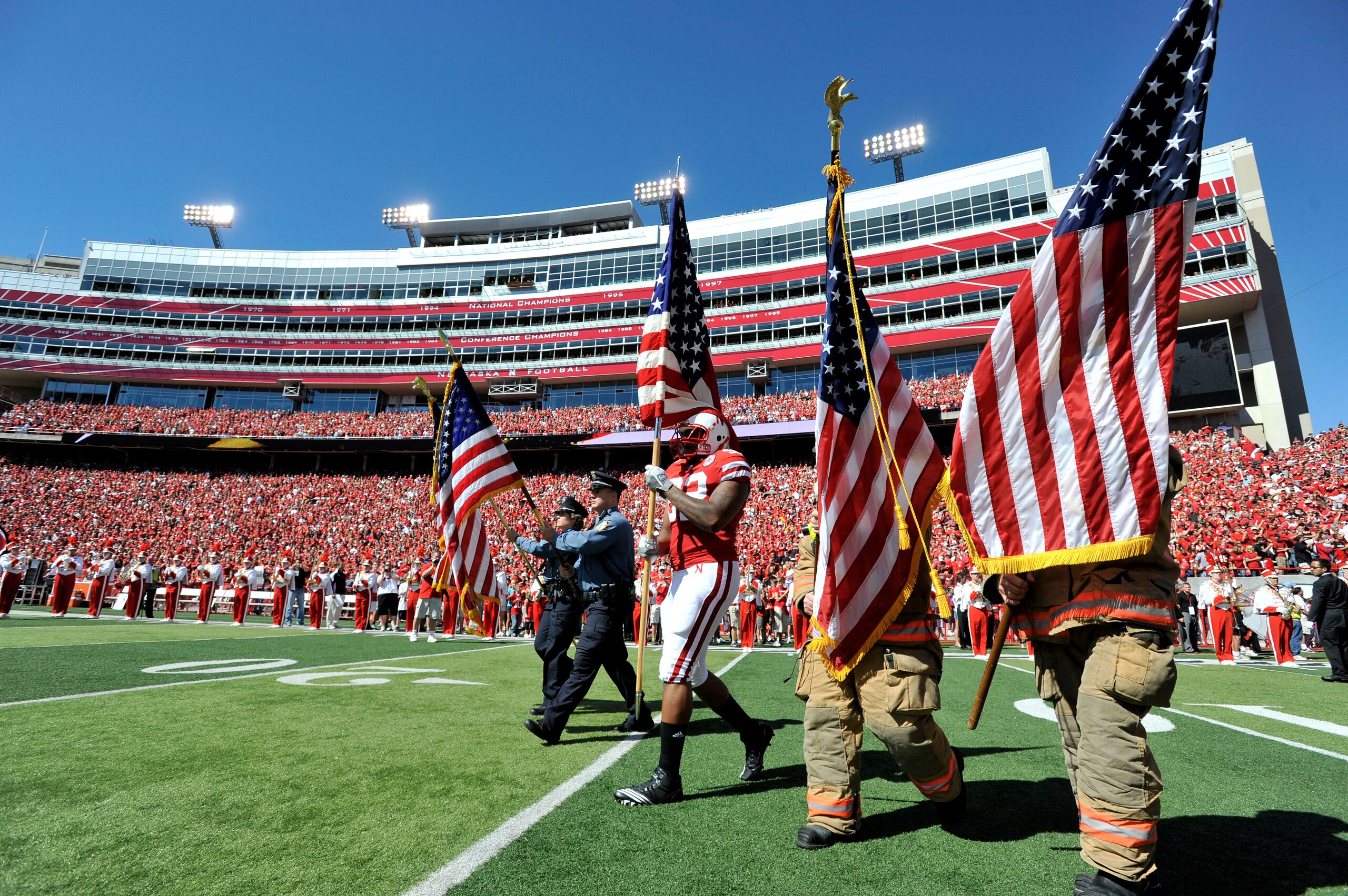 LINCOLN, NE - SEPTEMBER 11: Nebraska Cornhuskers defensive end Tyrone Fahie #92 carries the American Flag onto the field before their game against the Idaho Vandals at Memorial Stadium on September 4, 2010 in Lincoln, Nebraska. Nebraska Defeated Idaho 38 LINCOLN, NE - SEPTEMBER 11: Nebraska Cornhuskers defensive end Tyrone Fahie #92 carries the American Flag onto the field before their game against the Idaho Vandals at Memorial Stadium on September 4, 2010 in Lincoln, Nebraska. Nebraska Defeated Idaho 38
