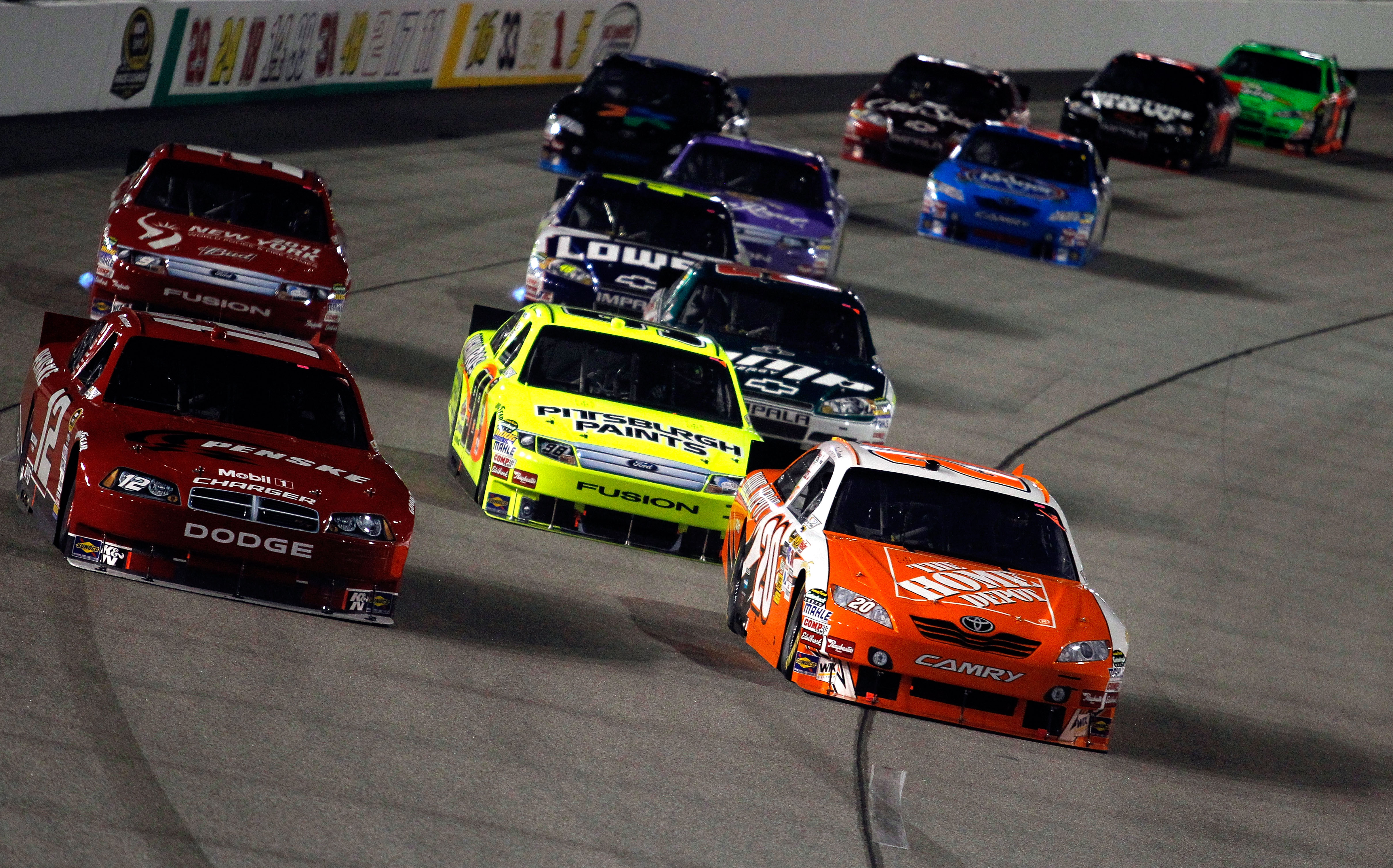 RICHMOND, VA - SEPTEMBER 11:  Brad Keselowski, driver of the #12 Penske Dodge,  and Joey Logano, driver of the #20 Home Depot Toyota, lead a group of cars during the NASCAR Sprint Cup Series Air Guard 400 at Richmond International Raceway on September 11,