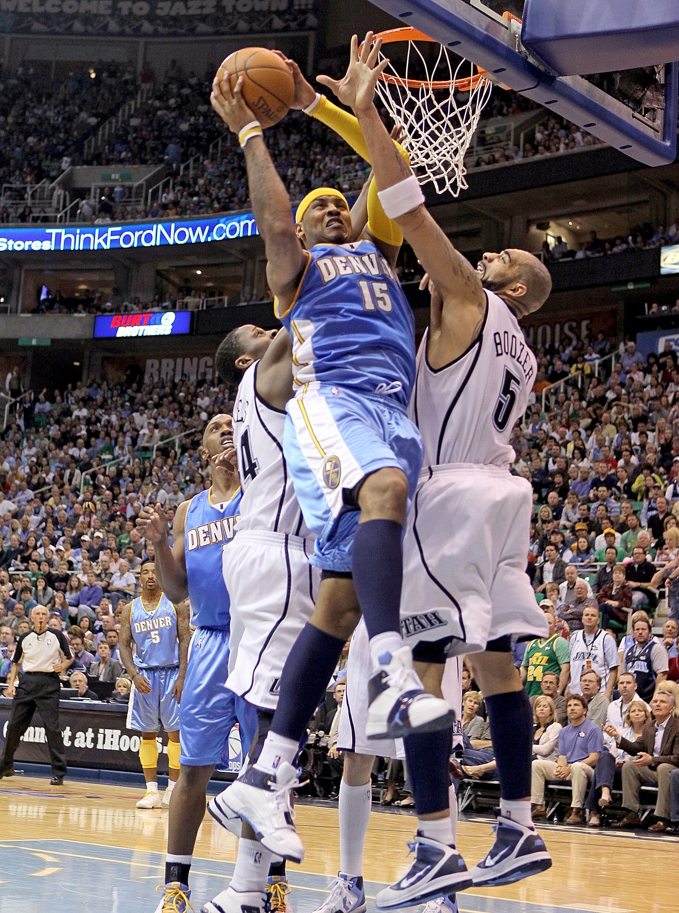 SALT LAKE CITY - APRIL 25:  Carmelo Anthony #15 of the Denver Nuggets shoots the ball while defended by Carlos Boozer #5 of the Utah Jazz during  Game Four of the Western Conference Quarterfinals of the 2010 NBA Playoffs at EnergySolutions Arena on April 