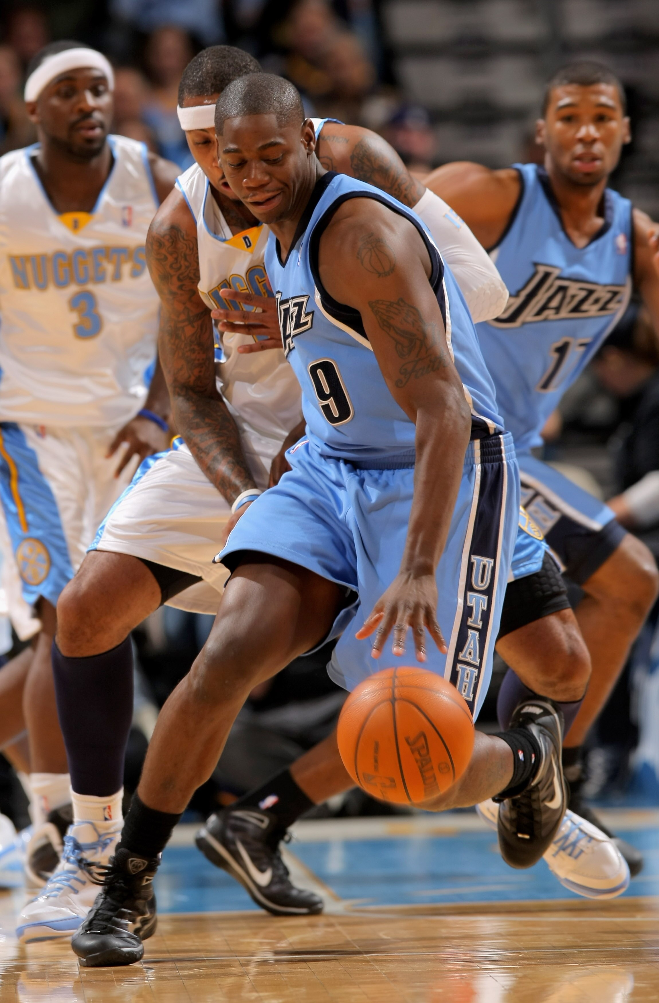DENVER - OCTOBER 28:  Ronnie Brewer #9 of the Utah Jazz dribbles the ball against the defense of Carmelo Anthony #15 of the Denver Nuggets during NBA action at Pepsi Center on October 28, 2009 in Denver, Colorado.  (Photo by Doug Pensinger/Getty Images)