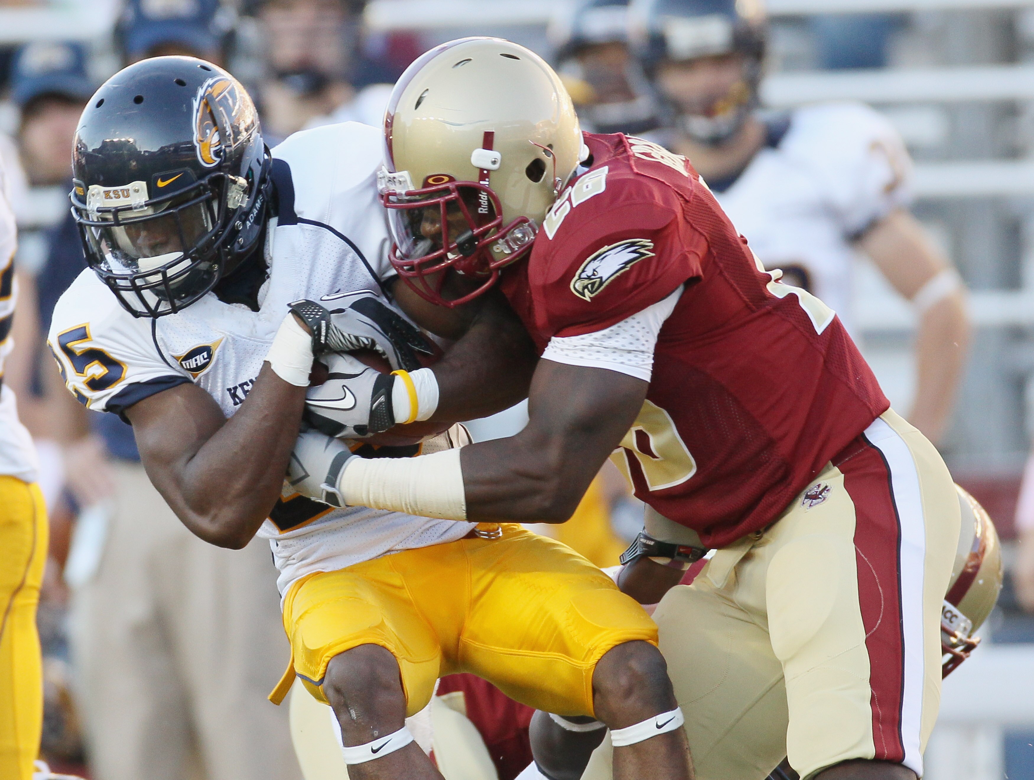 CHESTNUT HILL, MA - SEPTEMBER 11:  Anthony Bowman Jr. #26 of the Kent State Golden Flashes is tackled by Dominick LeGrande #26 of the Boston College Eagles on September 11, 2010 at Alumni Stadium in Chestnut Hill, Massachusetts. Boston College defeated Ke