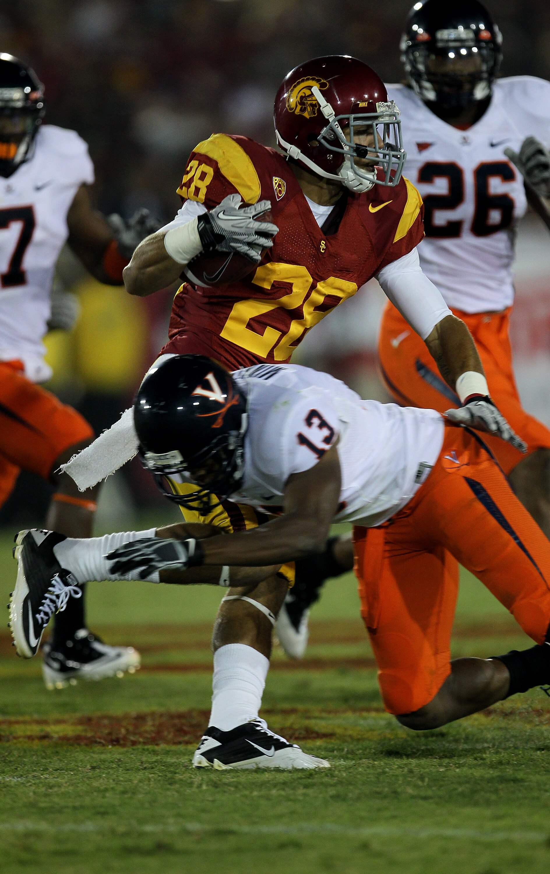 LOS ANGELES, CA - SEPTEMBER 11:  Running back Dillon Baxter #28 of the USC Trojans carries the ball against cornerback Chase Minnifield #13 of the Virginia Cavaliers at Los Angeles Memorial Coliseum on September 11, 2010 in Los Angeles, California. USC wo