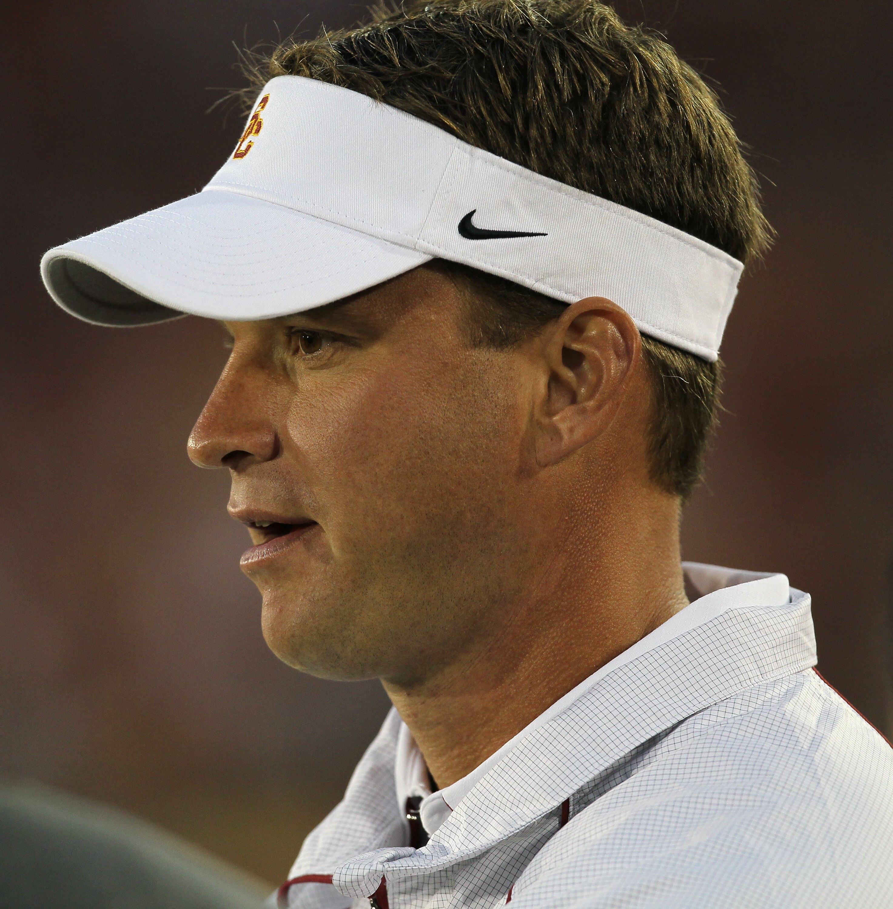 LOS ANGELES, CA - SEPTEMBER 11:  Head coach Lane Kiffin watches the USC Trojans warm up for their game with the Virginia Cavaliers at Los Angeles Memorial Coliseum on September 11, 2010 in Los Angeles, California.  (Photo by Stephen Dunn/Getty Images)