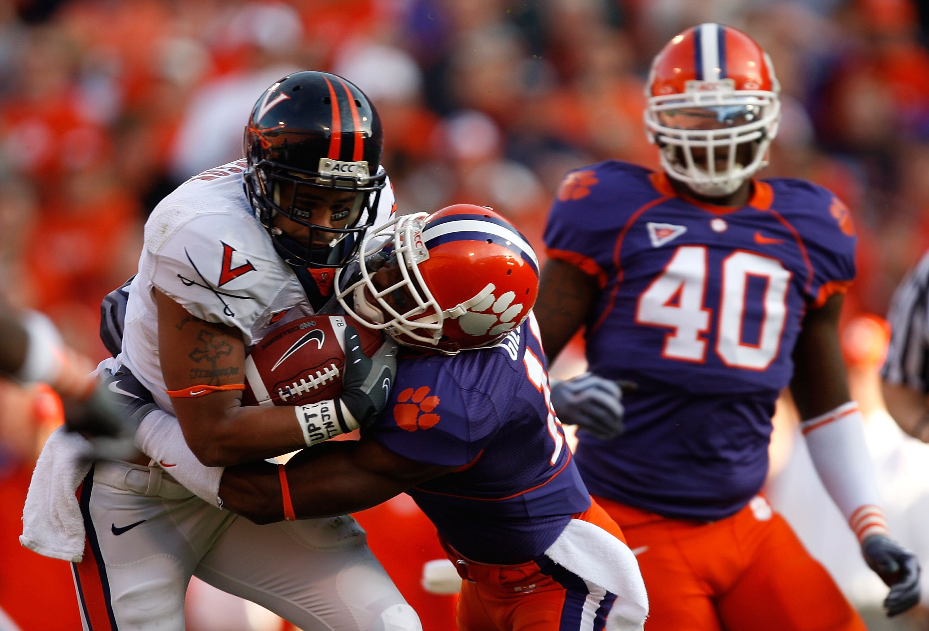 CLEMSON, SC - NOVEMBER 21:  Jameel Sewell #10 of the Virginia Cavaliers is tackled by Kavell Conner #17 of the Clemson Tigers during their game at Memorial Stadium on November 21, 2009 in Clemson, South Carolina.  (Photo by Streeter Lecka/Getty Images)