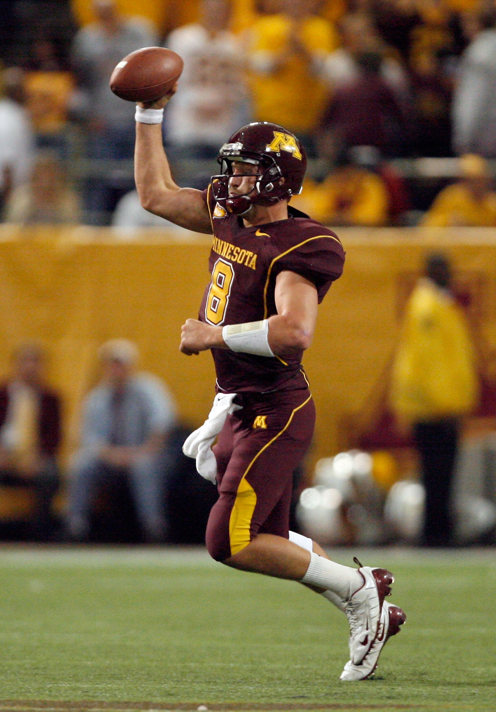 MINNEAPOLIS - NOVEMBER 01:  Adam Weber #8 of the Minnesota Golden Gophers fakes a pass down field as he scrambles out of  the pocket against the Northwestern Wildcats during the third quarter at the Hubert H.Humphrey Metrodome on November 1, 2008 in Minne
