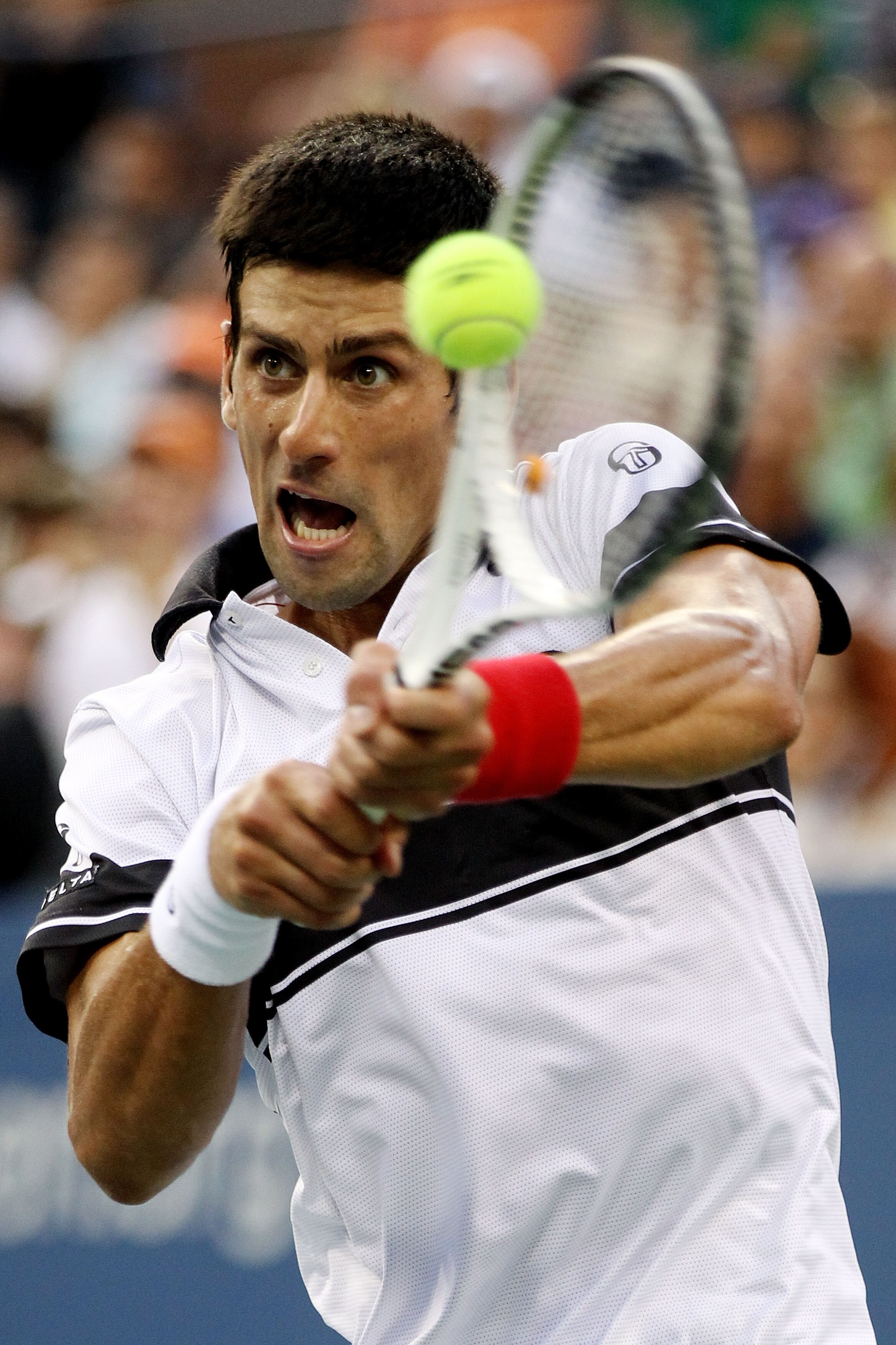 NEW YORK - SEPTEMBER 11: Novak Djokovic of Serbia returns a shot against Roger Federer of Switzerland during his men's singles semifinal match on day thirteen of the 2010 U.S. Open at the USTA Billie Jean King National Tennis Center on September 11, 2010 NEW YORK - SEPTEMBER 11: Novak Djokovic of Serbia returns a shot against Roger Federer of Switzerland during his men's singles semifinal match on day thirteen of the 2010 U.S. Open at the USTA Billie Jean King National Tennis Center on September 11, 2010