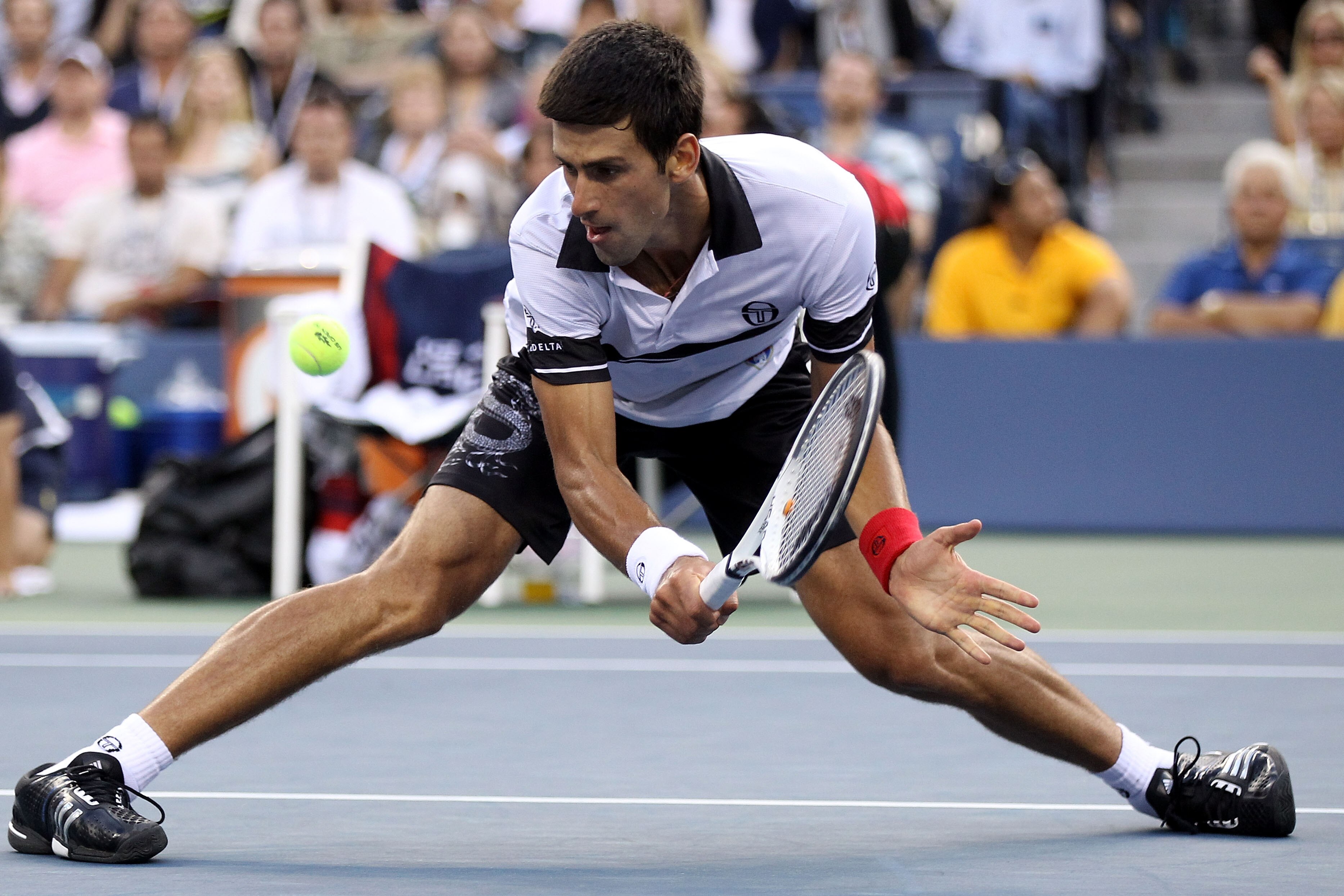 NEW YORK - SEPTEMBER 11: Novak Djokovic of Serbia stretches for a return shot against Roger Federer of Switzerland during his men's singles semifinal match on day thirteen of the 2010 U.S. Open at the USTA Billie Jean King National Tennis Center on Septe NEW YORK - SEPTEMBER 11: Novak Djokovic of Serbia stretches for a return shot against Roger Federer of Switzerland during his men's singles semifinal match on day thirteen of the 2010 U.S. Open at the USTA Billie Jean King National Tennis Center on Septe
