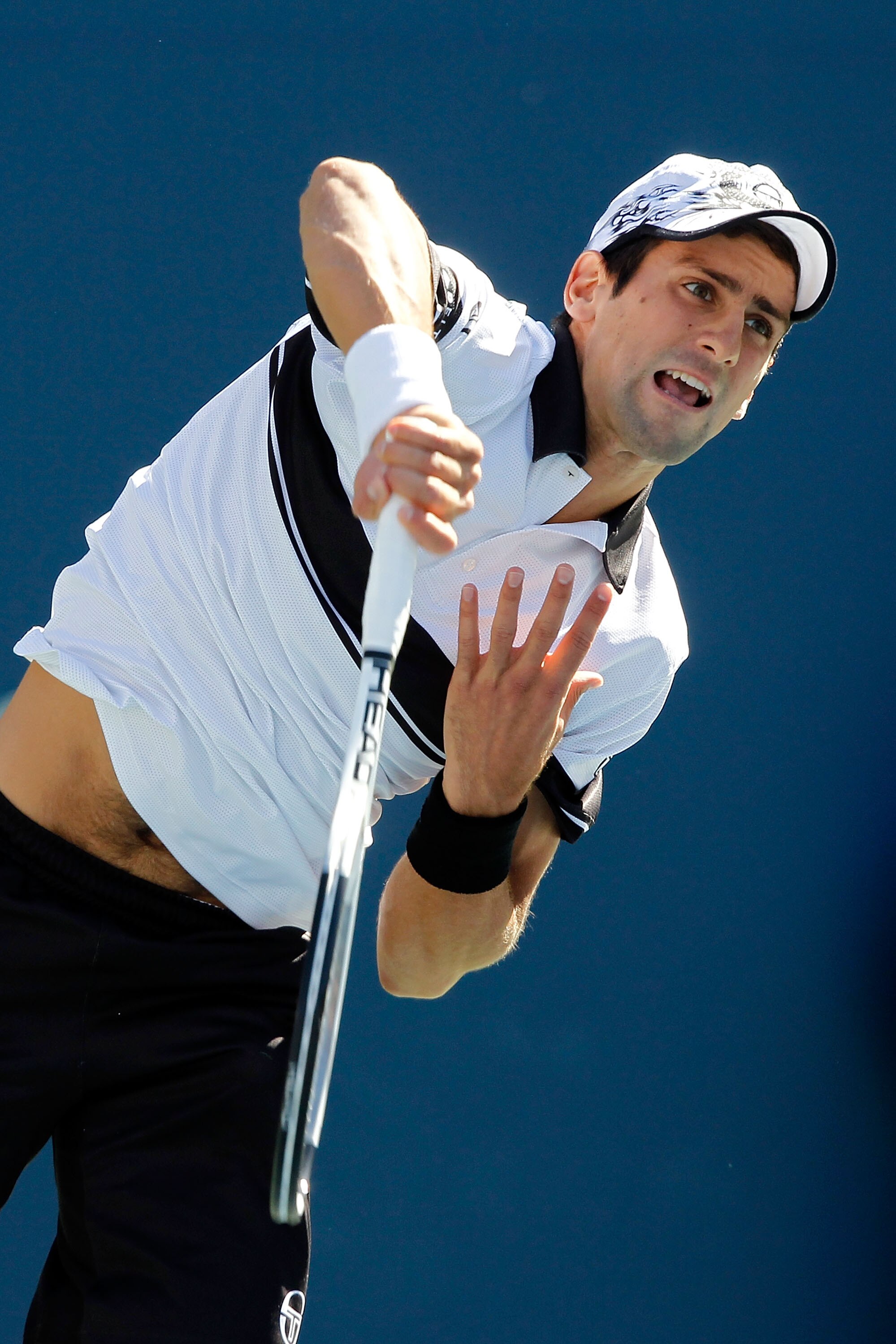 NEW YORK - SEPTEMBER 11: Novak Djokovic of Serbia serves against Roger Federer of Switzerland during his men's singles semifinal match on day thirteen of the 2010 U.S. Open at the USTA Billie Jean King National Tennis Center on September 11, 2010 in the NEW YORK - SEPTEMBER 11: Novak Djokovic of Serbia serves against Roger Federer of Switzerland during his men's singles semifinal match on day thirteen of the 2010 U.S. Open at the USTA Billie Jean King National Tennis Center on September 11, 2010 in the
