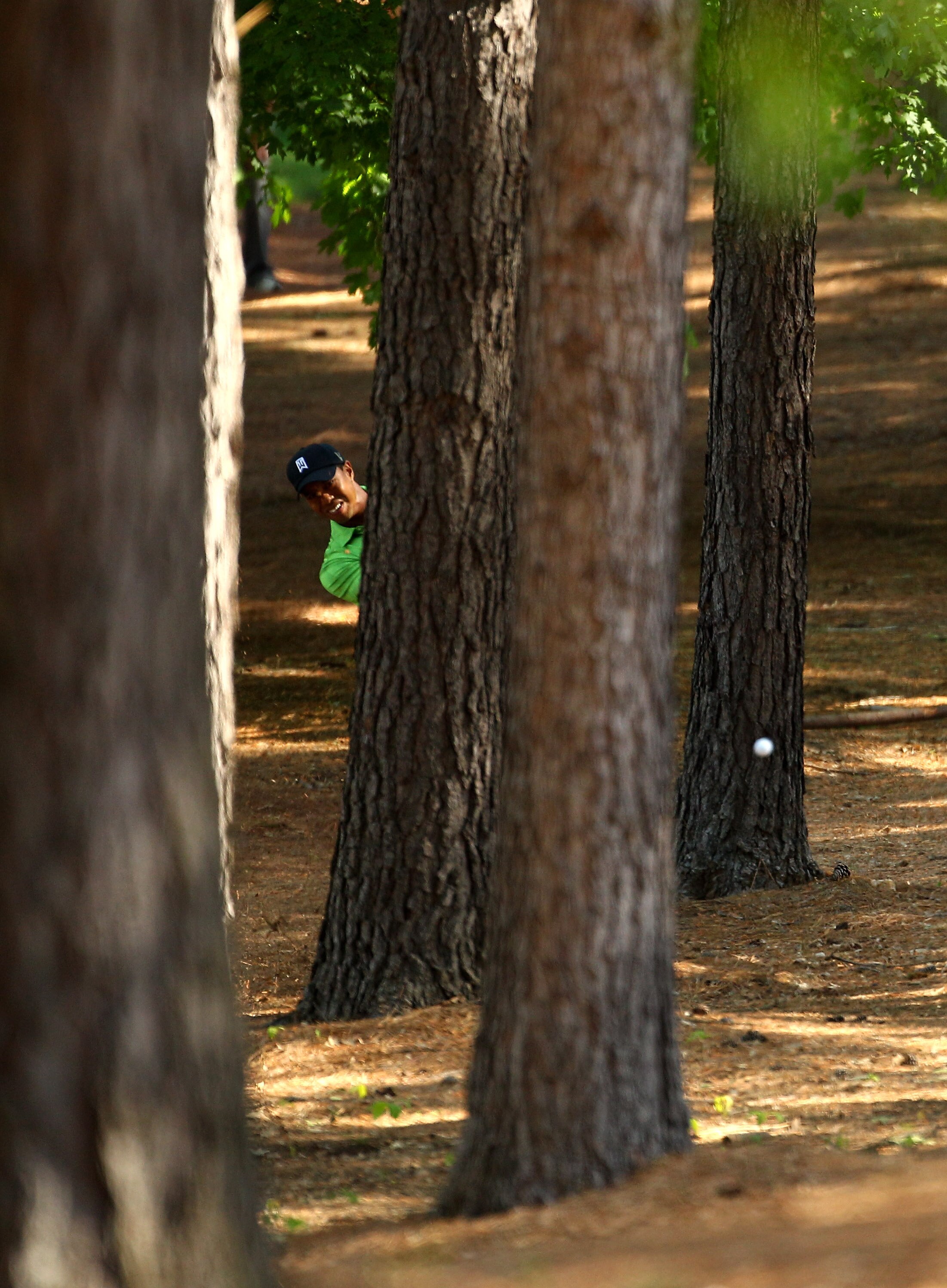 CHARLOTTE, NC - APRIL 29:  Tiger Woods plays from amoungst the trees on the 1st hole during the first round of the Quail Hollow Championship at Quail Hollow Country Club on April 29, 2010 in Charlotte, North Carolina.  (Photo by Richard Heathcote/Getty Im