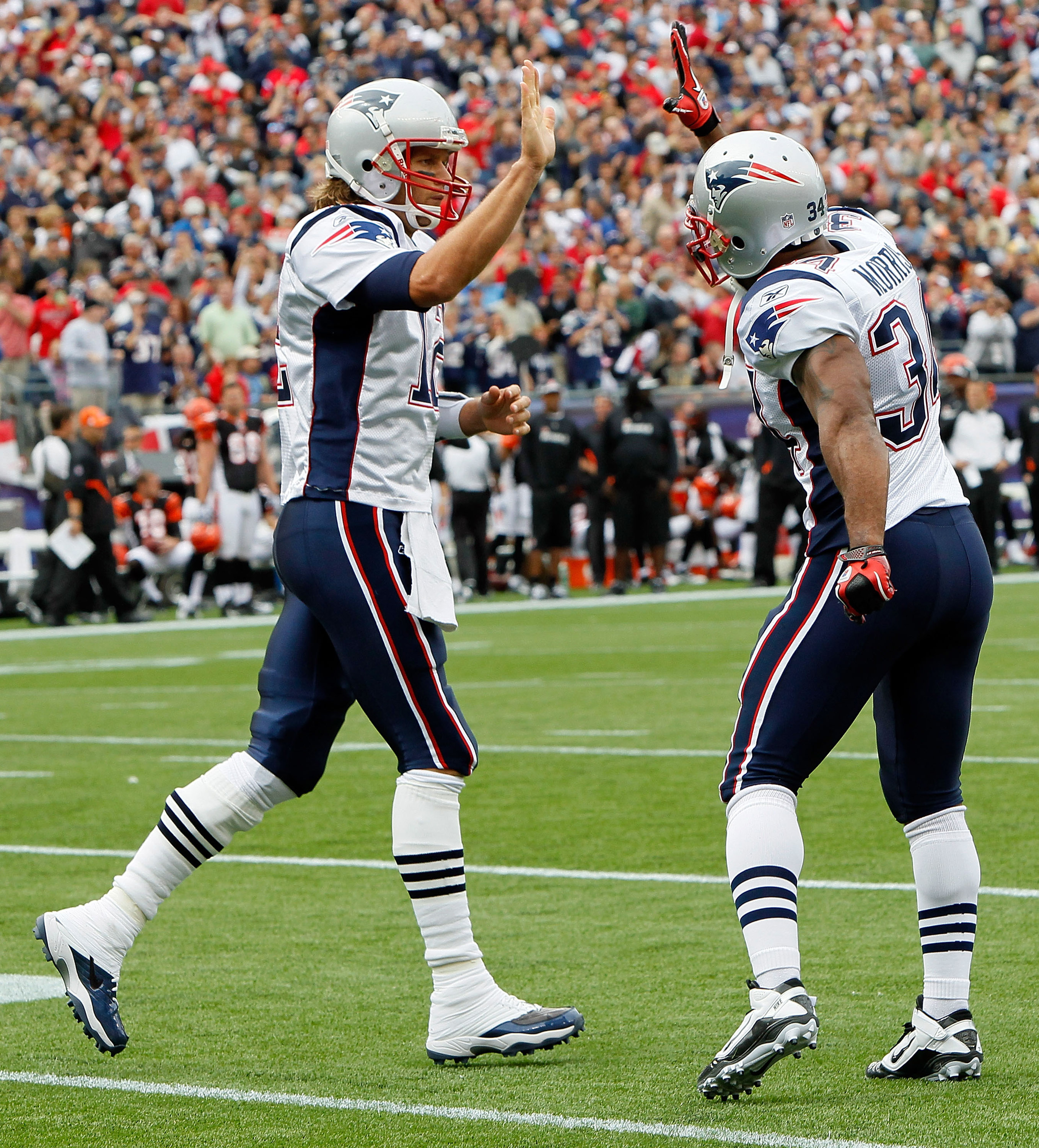 FOXBORO, MA - SEPTEMBER 12: Quarterback Tom Brady #12 of the New England Patriots celebrates with teammate Sammy Morris #34 during a the NFL season opener against the Cincinnati Bengals at Gillette Stadium on September 12, 2010 in Foxboro, Massachusetts.