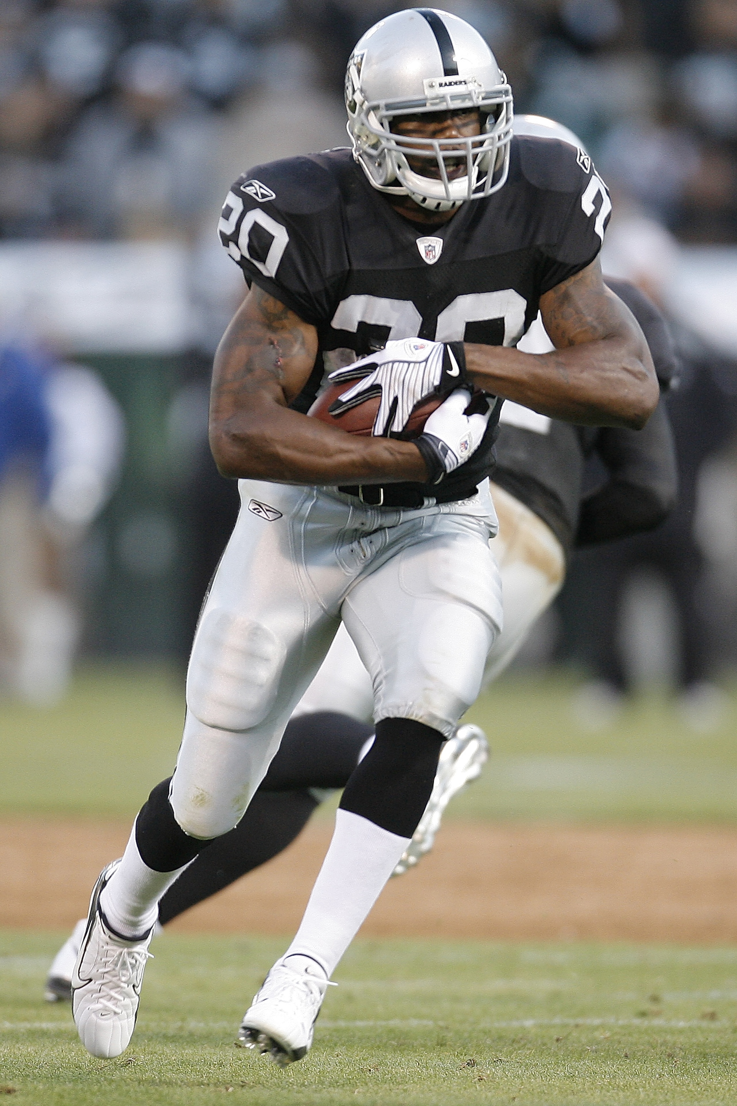 OAKLAND, CA - AUGUST 23:  Running back Darren McFadden #20 of the Oakland Raiders heads downfield against the Arizona Cardinals during a preseason game on August 23, 2008 at the McAfee Coliseum in Oakland, California.  (Photo by Greg Trott/Getty Images)