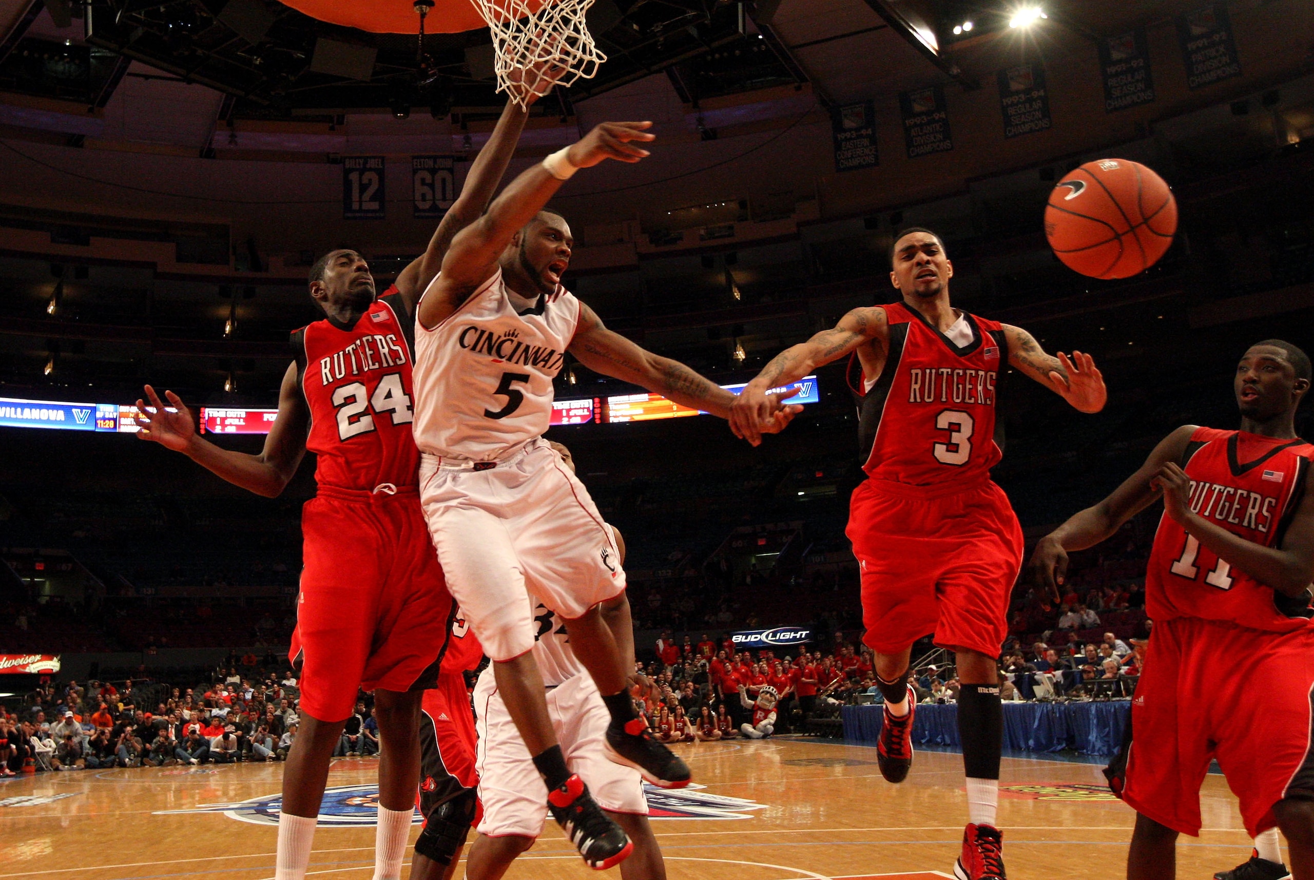 NEW YORK - MARCH 09: Deonta Vaughn #5 of the Cincinnati Bearcats fights for a ball with Jonathan Mitchell #24 and Mike Rosario #3 of the Rutgers Scarlet Knights during the first round game of the Big East Basketball Tournament at Madison Square Garden on