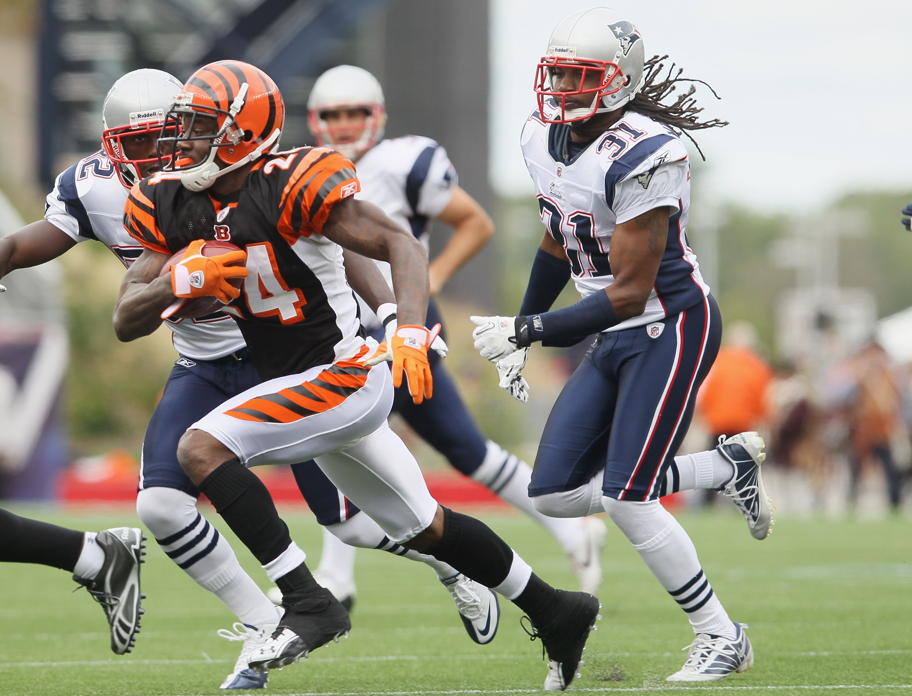 FOXBORO, MA - SEPTEMBER 12:  Adam Jones #24 of the Cincinnati Bengals tries to avoid Kyle Arrington #27 and Brandon Meriweather #31 of the New England Patriots during the NFL season opener on September 12, 2010 at Gillette Stadium in Foxboro, Massachusett