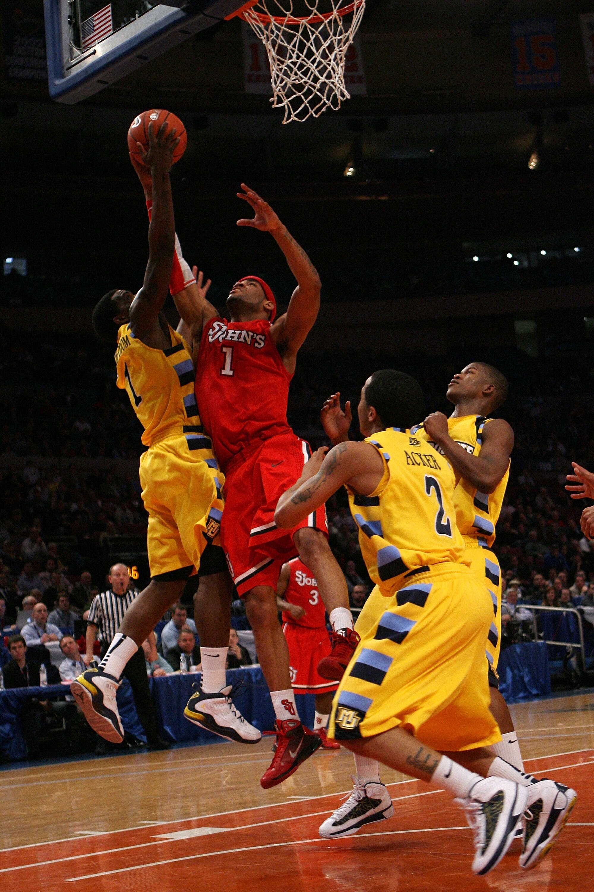 NEW YORK - MARCH 10:  Darius Johnson-Odom #1 of the Marquette Golden Eagles blocks the shot of D.J. Kennedy #1 of the St. John's Red Storm during the second round of 2010 NCAA Big East Tournament at Madison Square Garden on March 10, 2010 in New York City