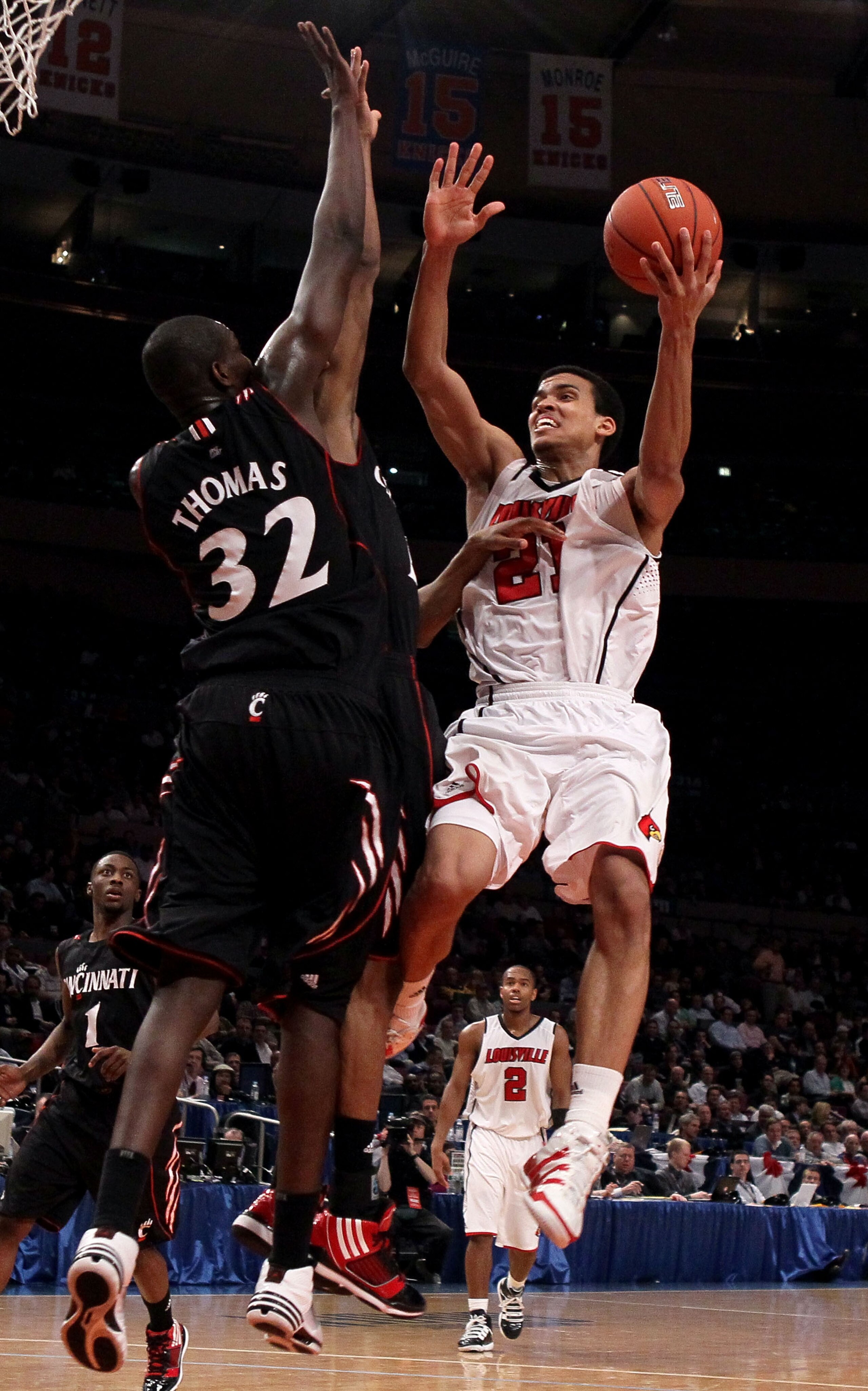 NEW YORK - MARCH 10: Jared Swopshire #21 of the Louisville Cardinals goes to the hoop against Ibrahima Thomas #32 of the Cincinnati Bearcats during the second round of 2010 NCAA Big East Tournament at Madison Square Garden on March 10, 2010 in New York Ci