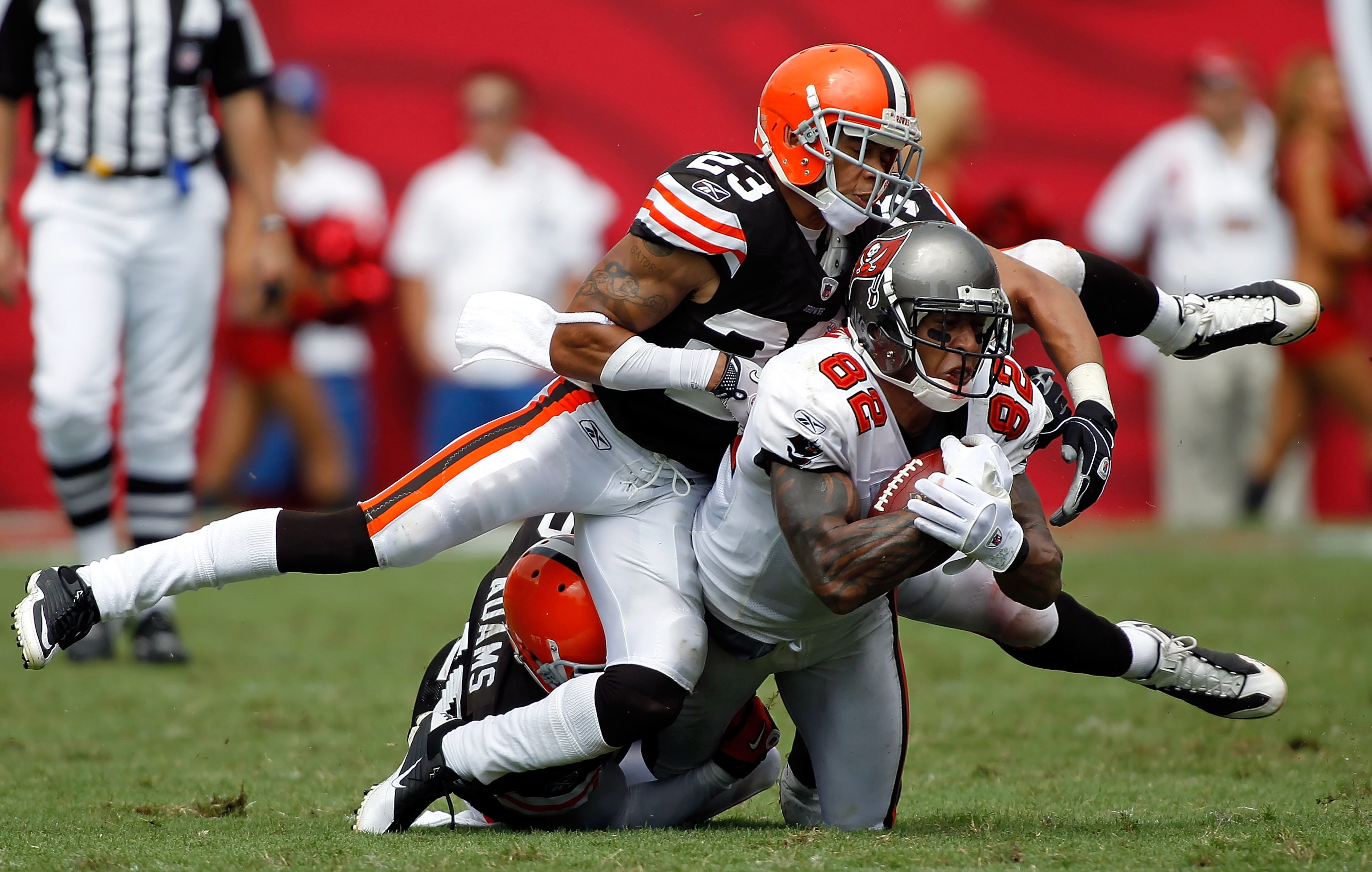 TAMPA, FL - SEPTEMBER 12:  Tight end Kellen Winslow #82 of the Tampa Bay Buccaneers is tackled by defenders Joe Haden #23 and Mike Adams #20 of the Cleveland Browns during the season opener game at Raymond James Stadium on September 12, 2010 in Tampa, Flo