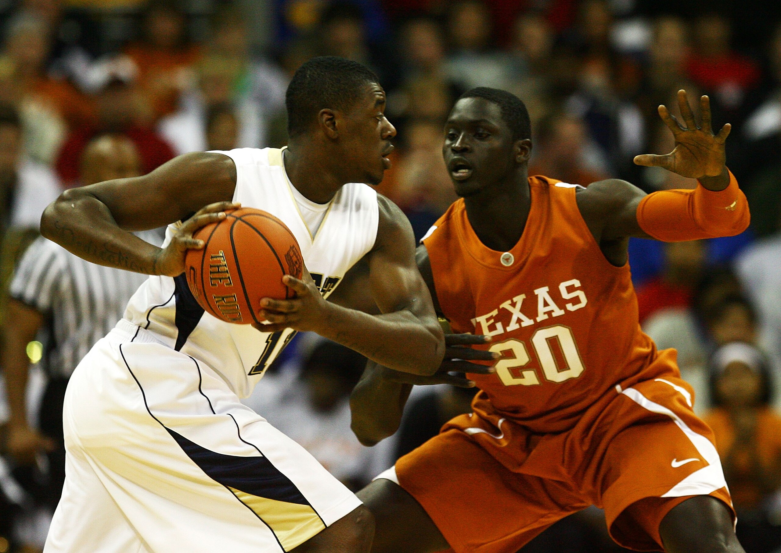 KANSAS CITY, MO - NOVEMBER 24:  Dante Taylor #11 of the Pittsburgh Panthers controls the ball as Alexis Wangmene #20 of the Texas Longhorns defends during the CBE Classic championship game on November 24, 2009 at Sprint Center in Kansas City, Missouri.  (