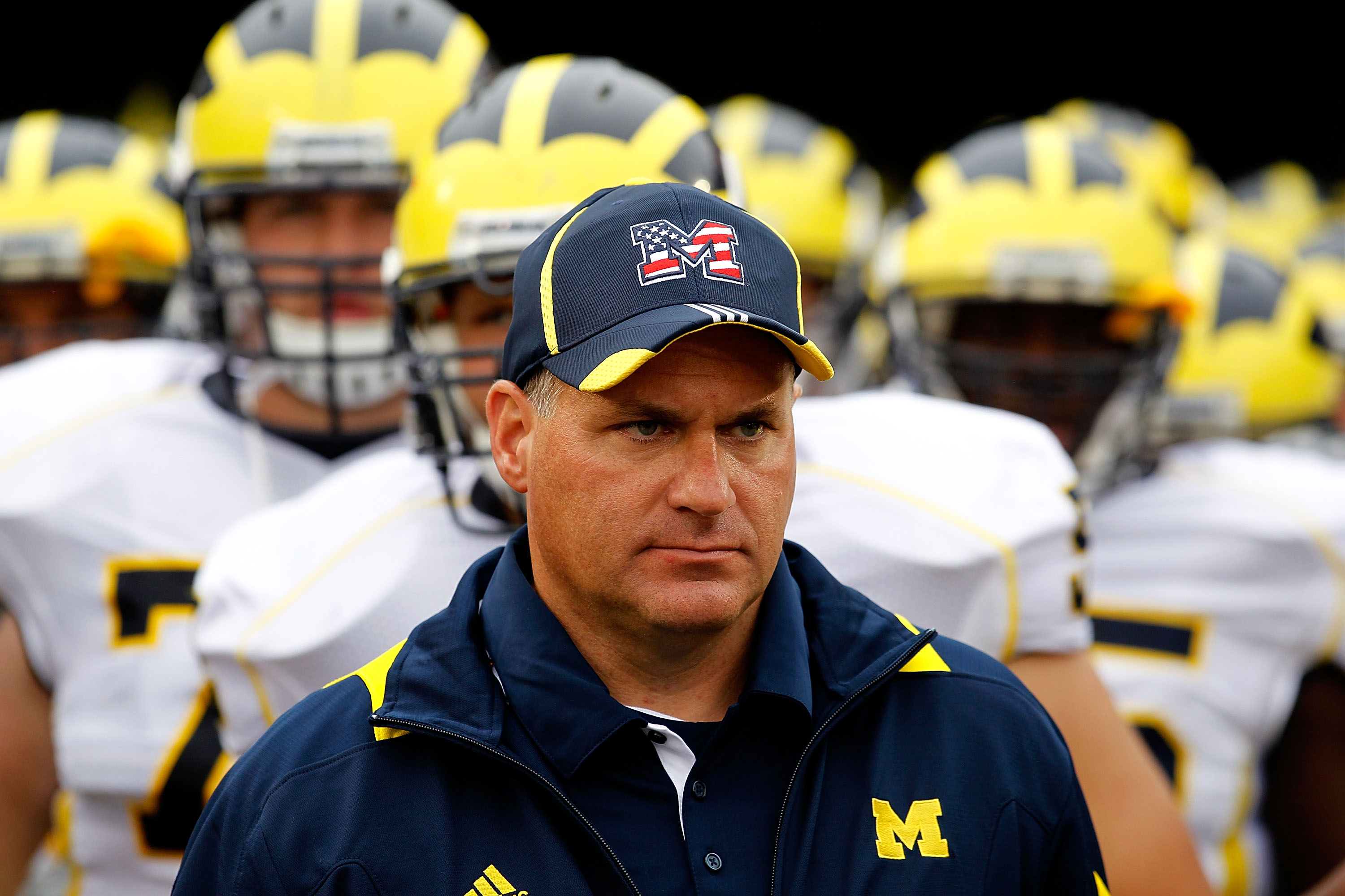 SOUTH BEND, IN - SEPTEMBER 11: Head coach Rich Rodriguez of the Michigan Wolverines waits with his team before entering the field for a game against the Notre Dame Fighting Irish at Notre Dame Stadium on September 11, 2010 in South Bend, Indiana. Michigan