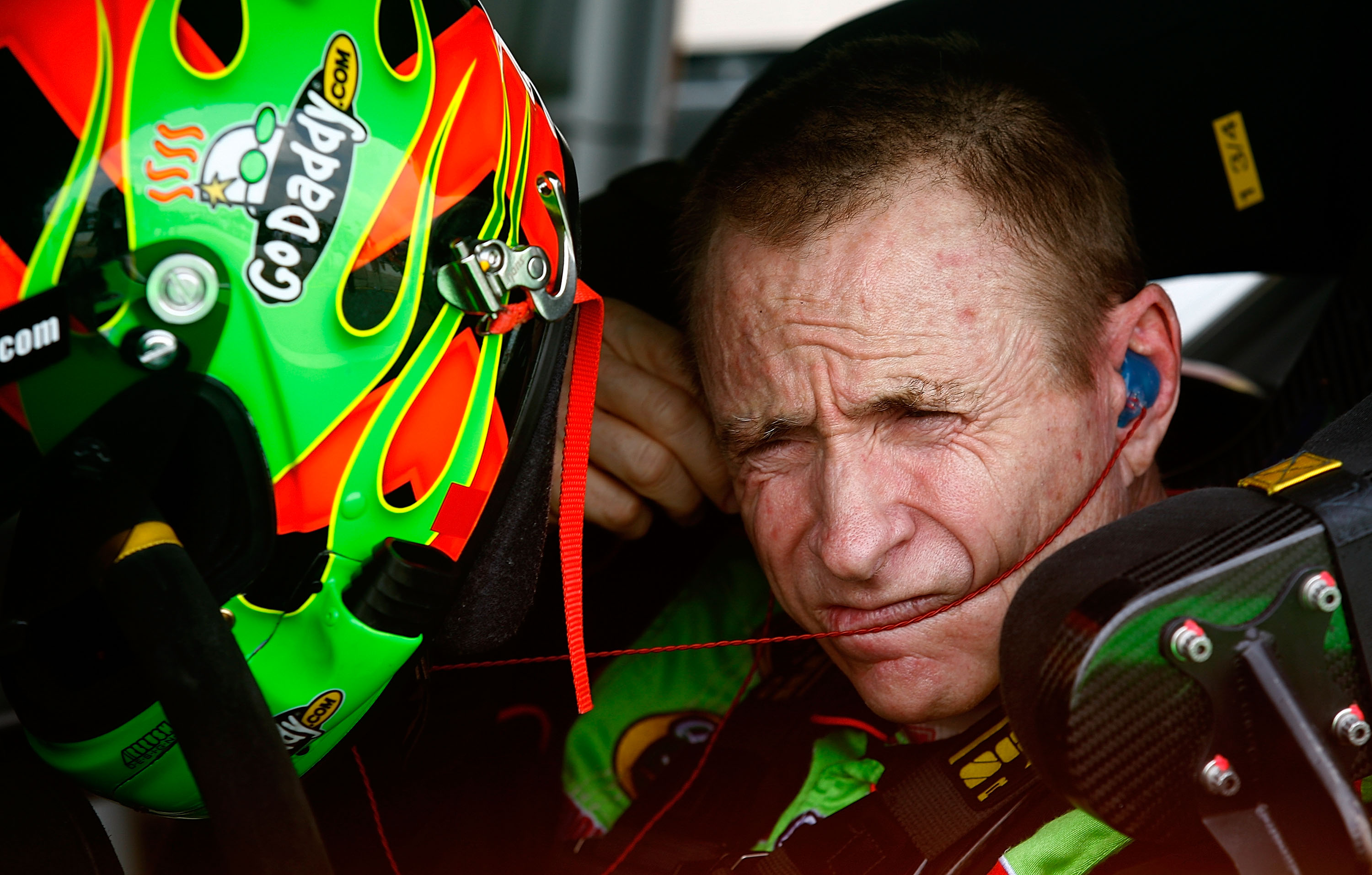 BROOKLYN, MI - AUGUST 13:  Mark Martin, driver of the #5 GoDaddy.com Chevrolet, makes adjustments in his car during qualifying for the NASCAR Sprint Cup Series CARFAX 400 at Michigan International Speedway on August 13, 2010 in Brooklyn, Michigan.  (Photo