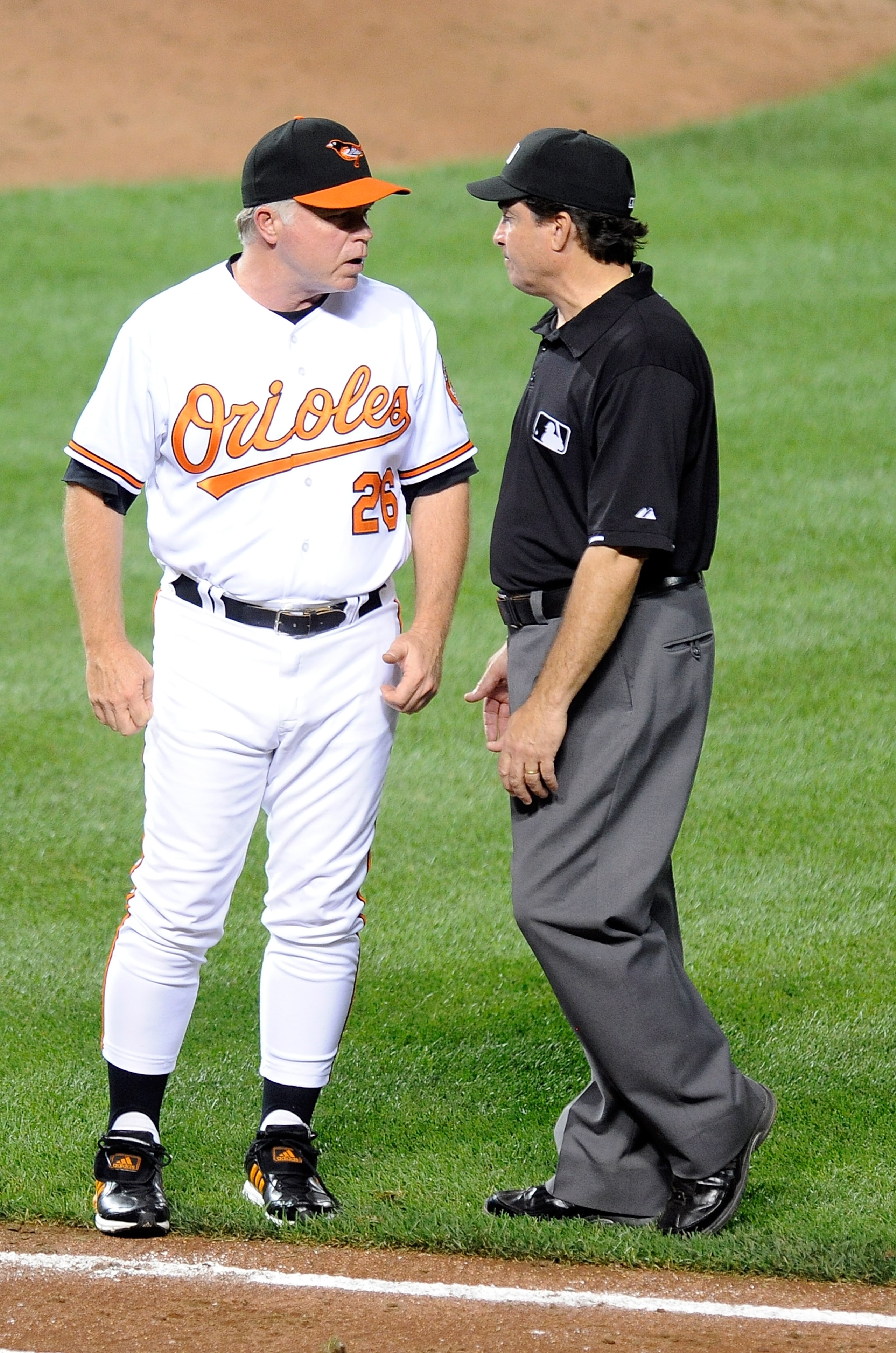 BALTIMORE - SEPTEMBER 02:  Manager Buck Showalter of the Baltimore Orioles talks with second base umpire Ed Rapuano during the game against the Boston Red Sox at Camden Yards on September 2, 2010 in Baltimore, Maryland.  (Photo by Greg Fiume/Getty Images)