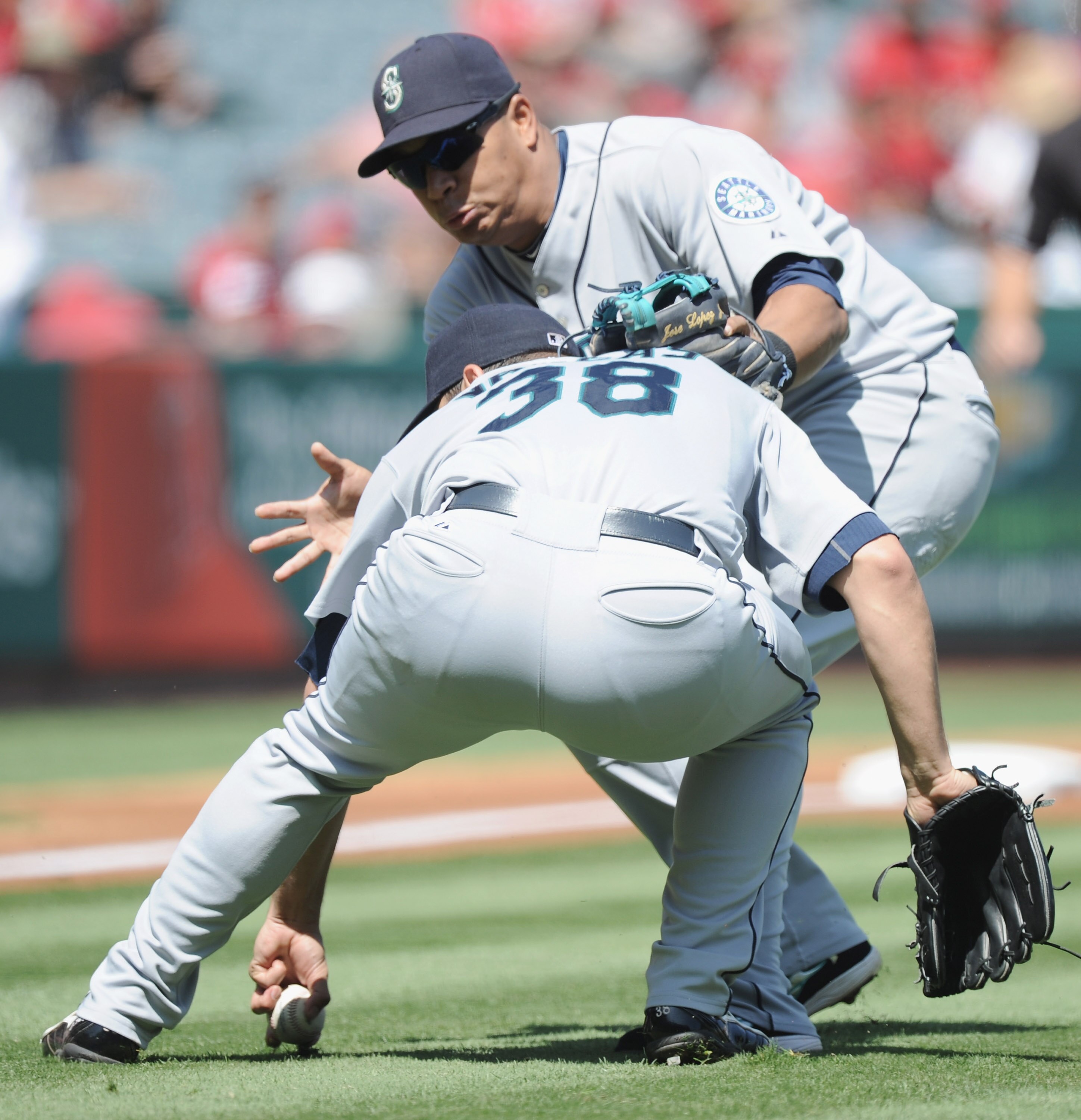 ANAHEIM, CA - SEPTEMBER 12:  Jose Lopez #4 of the Seattle Mariners collides with pitcher Jason Vargas #38 fielding the ball off the bat of Howie Kendrick #47 of the Los Angeles Angels of Anaheim during the first inning at Angel Stadium on September 12, 20