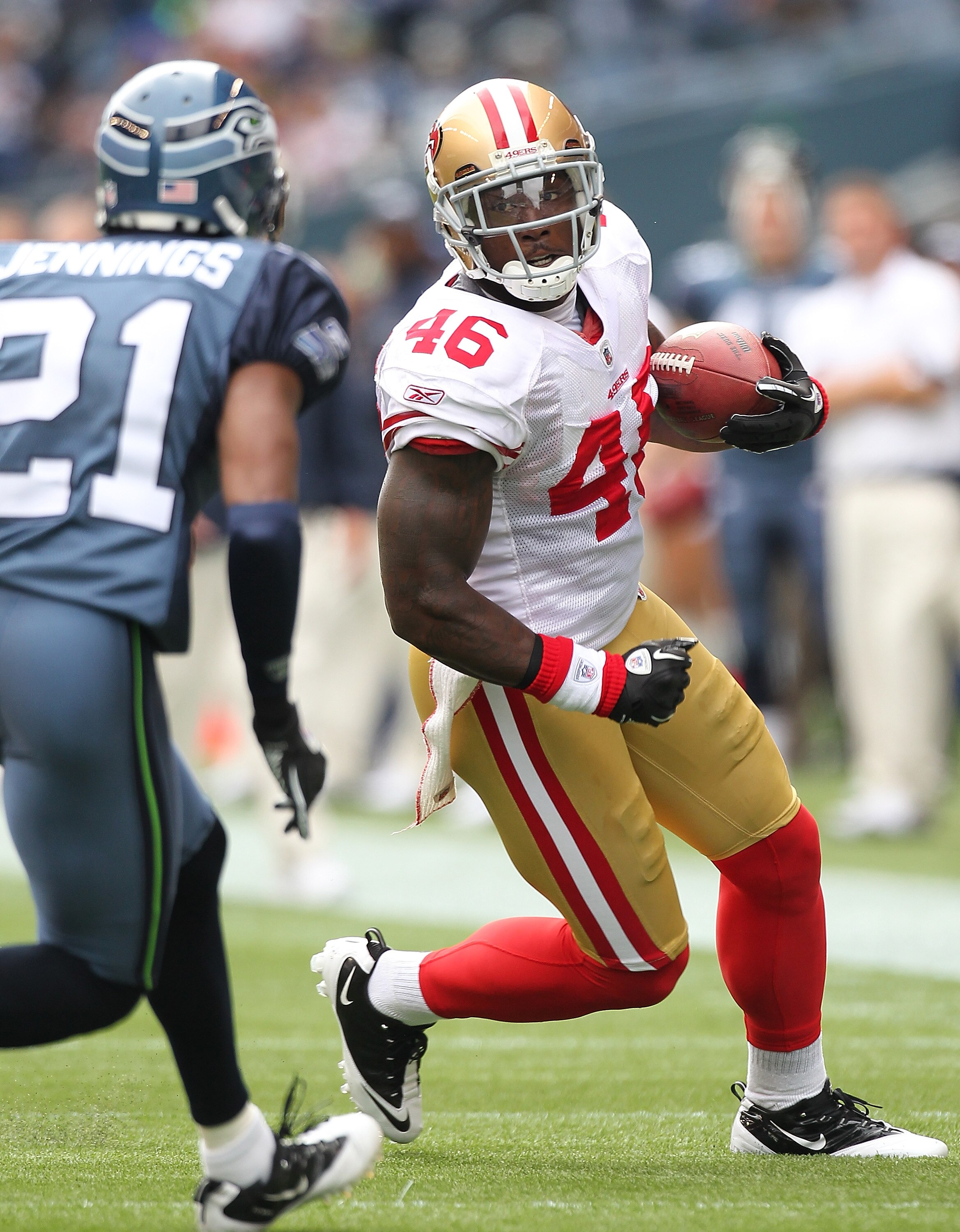 SEATTLE - SEPTEMBER 12:  Running back Delanie Walker #46 of the San Francisco 49ers rushes against Kelly Jennings #21 during the NFL season opener against the Seattle Seahawks at Qwest Field on September 12, 2010 in Seattle, Washington. (Photo by Otto Gre