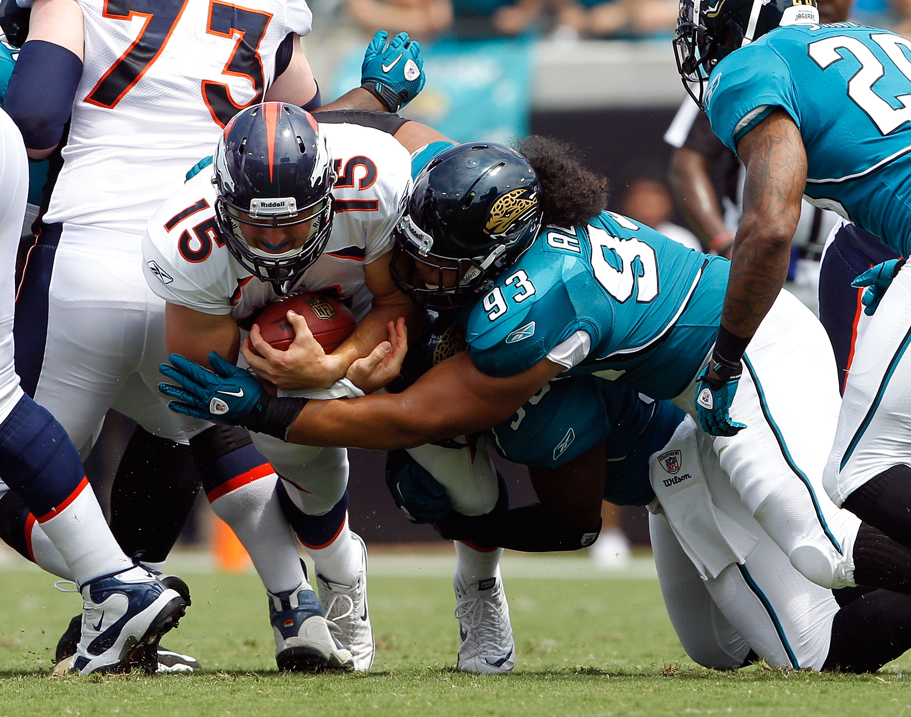 JACKSONVILLE, FL - SEPTEMBER 12:  Tyson Alualu #93 of the Jacksonville Jaguars tackles Tim Tebow #15 of the Denver Broncos during the NFL season opener game at EverBank Field on September 12, 2010 in Jacksonville, Florida.  (Photo by Sam Greenwood/Getty I